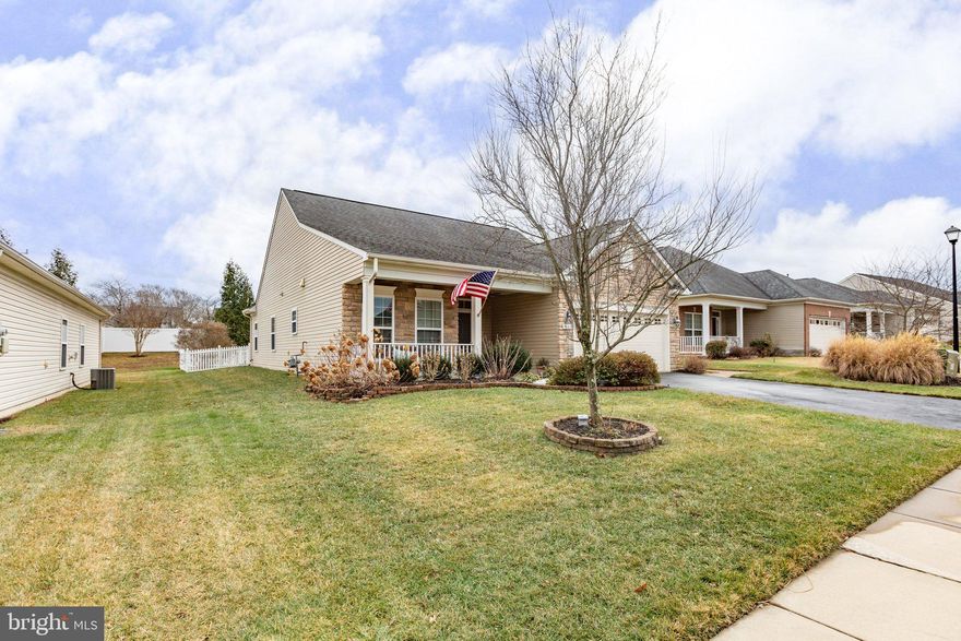 Nestled within the vibrant Active Adult community of Virginia Heritage, this charming one-level detached villa home sits gracefully on a quiet no-thru street. Its stunning stone front adds to the curb appeal, welcoming you with a spacious, shaded front porch and a wide entryway.  

Stepping inside, the warmth of hardwood floors greets you in the foyer, setting the stage for a thoughtfully designed layout. To the left, a bright office or den boasts a large window overlooking the front yard and porch, providing the perfect spot for work or relaxation. Moving down the central hallway, the home opens to an inviting kitchen, complete with a large center island, an abundance of cabinets, and sleek countertops. Gas cooking, convenient pullouts, and other chef-friendly amenities make this kitchen a dream for both entertaining and preparing homemade meals.  

The open-concept family and dining room area is both spacious and airy, with sliding glass doors that lead to an oversized patio and a beautifully fenced backyard—ideal for outdoor gatherings or quiet moments of retreat. A comfortable guest bedroom, accompanied by a well-appointed hall bath, offers privacy and convenience for visitors. Meanwhile, the oversized owner’s suite is a true sanctuary, featuring two generous closets and a luxurious bathroom with a custom ceramic tile shower surround, a soaking tub, and dual vanities.  

Practicality meets comfort in the laundry room, which is strategically located off the roomy two-car garage that includes built-in storage. Thoughtful enhancements by the owner add to the home’s appeal, including professionally installed electrical grounding, solar lights on the patio, a stamped concrete walkway from the driveway to the backyard, a charming white vinyl picket fence, and elevated toilets for added comfort.  

Just minutes away, the community clubhouse offers an abundance of activities, from indoor and outdoor pools to pickleball and tennis courts. Residents can also enjoy billiards, a library, a meeting room, a members’ gym, and scenic walking trails. With a full-time lifestyle director curating events, lectures, and gatherings, there’s always something to engage in and enjoy. HOA dues include trash and snow removal plus high spped internet and clubhouse privileges. This home blends elegance, functionality, and community, offering an unparalleled living experience in Virginia Heritage. 

This community is convenient to I-95, commuter lots for those buyers still commuting, hospitals, shopping, and dining. Downtown Fredericksburg offers the charm of a colonial port town with boutiques and charming shops, a riverfront park, and restaurants. In addition, this home is just 3 miles from the the nation's largest privately-owned outpatient clinic for the Department of Veterans Affairs in Spotsylvania County.  The four-story, 450,000 square foot clinic is built on a 48-acre site located on a commercial site with an estimated completion date of March 2025! This area continues to evolve and improve. Make it your home today!