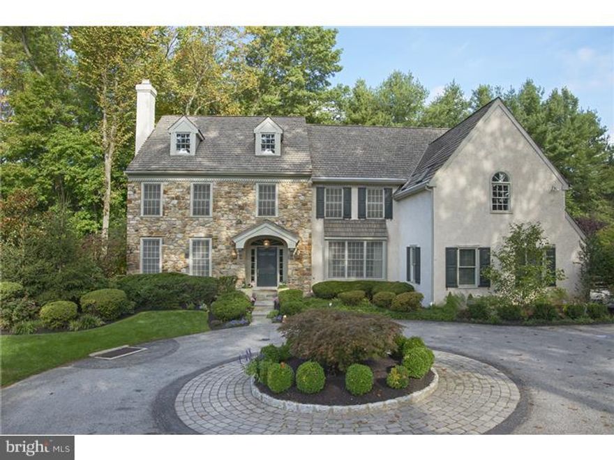 Beautifully constructed sun-filled 20 year old stone colonial in premium Bryn Mawr location offers five bedrooms and 4.2 baths on three finished levels on private, fenced parcel with stone terraces, gardens and pool. Traditional center foyer floor plan opens to a gracious two story foyer. To the left find the formal living room with wood burning fireplace and gleaming hardwood floors. To the right of foyer is the formal dining room with deep bay window, chair rail and service door to the kitchen.  A dramatic two story family room with an exposed stone fireplace is surrounded by windows and offers french door exit to the rear stone terrace. All white kitchen flows into the breakfast room and beyond to the family room creating one large, open informal yet high functioning space.  A short hall provides access to the homes study. A full wall of custom built ins creates ideal private, work space while three exposures of light make for a sunlit retreat. Two powder rooms, laundry and generous storage complete this level. Ascend the main stair to the master bedroom. A tray ceiling adds elegance and interest. Fully outfitted his/her closets and deluxe master bath with under window jetted tub and standing shower. A double vanity is located in the dressing area allowing for maximum usage of the master suite. Four additional large family/guest bedrooms and two baths are also found on this level.  Fully finished lower level with mirrored gym, home theater,large recreation room, full bath and craft room with closet provides exciting additional family space.