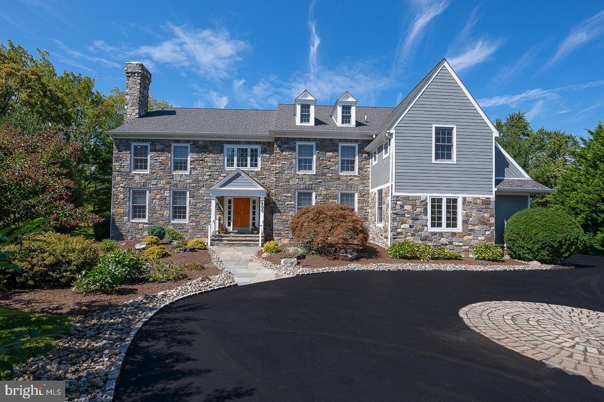 Stately Stone Colonial? Circular driveway? Open floor plan? All of this and more in this American Dream House, masterfully designed, beautifully and privately situated, and only 20 years old, in prestigious north side Villanova, Lower Merion Township. This exceptional 5-bedroom, 5.2-bath residence sits on a 0.72-acre flat lot in an exclusive enclave of only 9 homes. The modern floor plan includes a home office, five living areas, a chef's kitchen, a finished lower level, fantastic storage, and abundant natural light throughout. The front door opens to a sensational grand foyer and custom-turned staircase, with gleaming 3/4" hardwood floors and a front-to-back view of the home.
Surrounding the foyer are elegant formal Living and Dining rooms. To the right, the formal Dining Room showcases a tray ceiling, wainscoting, and direct access to the Butler Pantry. To the left, the formal Living Room impresses with nearly floor-to-ceiling windows, double crown molding, and a marble-faced gas fireplace. French doors reveal a spacious Office/Library with floor-to-ceiling bookcases and lush green views, offering both serenity and functionality for today’s work-from-home lifestyle. The Butler Pantry, complete with a wet bar and wine refrigerator, leads into the expansive gourmet Kitchen with a spacious center island, granite countertops, Sub-Zero refrigerator, large 48-inch Viking stainless gas cook top, Dacor 30-inch double wall ovens, Bosch dishwasher, and a walk-in pantry. A double-height Palladian window and skylights bring the outdoors in. A Sunny Breakfast Room with sliders leads to a dramatic 4-season Solarium with a heated floor, perfect for indoor-outdoor dining and entertaining.  With its wrap-around glass and views of the grounds, you may wish to spend your entire day in this bright and delightful space. An adjacent covered deck adds even more indoor-outdoor square footage to the footprint. The Kitchen is open to an expansive Family Room, the center of the home, featuring a travertine gas fireplace, coffered ceiling, and nearly floor-to-ceiling windows allowing views of the rear grounds. All this connectivity between the main level rooms creates the perfect environment for either casual and comfortable relaxation with family or lavish hosting with many friends.  Two Powder Rooms, a large Laundry Room, and a Mudroom area leading to a side-entry three-car garage complete the main level. On the second level, the primary bedroom suite features a large sitting room, dressing and vanity area, his and hers walk-in-closets, and a deluxe marble-clad spa bath with a marble shower, Jacuzzi tub, dual vanity and cabinetry, and soothing neutral colors for a serene retreat. The second Bedroom is another large suite, with a full bath, a good-sized walk-in closet, and a Sitting Room/Office/Library with built-in bookshelves. The third and fourth Bedrooms, amply sized with excellent closets, share a Jack & Jill bath. The fifth bedroom includes a full bath and a nice walk-in closet. All the vanities have Corian counters with integral bowls.
The third floor is perfect for extra storage or the possibility of more living space. By the Master Suite, there is a back staircase leading to the Kitchen/Mudroom area for easy exit. A gigantic finished lower level provides additional living space, a dedicated exercise area, three storage rooms, a full bath, and a blank slate on which to build a Playroom, Craft Room, Home Theater, and/or an additional bedroom. This 20-year-old beauty has had all stucco replaced with two stone chimneys and Hardie board. Beyond the property itself, the location elevates the experience. Walk to Black Rock Middle School, enjoy easy access to award-winning public and private schools, and take advantage of nearby shopping, fine dining, and beautiful parks. King of Prussia and Center City Philadelphia are just 20 minutes away, while Manhattan is an easy 90-minute trip—placing the best of the region at your doors