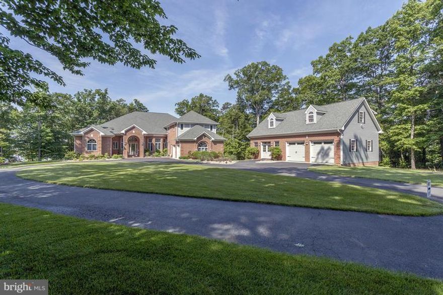 6000 sq ft Custom brick home nestled on private peninsula overlooking Patuxent River. Whether entertaining in gourmet kit overlooking fam rm w/abundant views/windows everywhere or retreating to the lanai in the evening, this home is the dream lifestyle. Det 2 car garage w/loft allows for addl parking, boats, in home business. Every upgrade imaginable incl indoor/outdoor full house surround system.