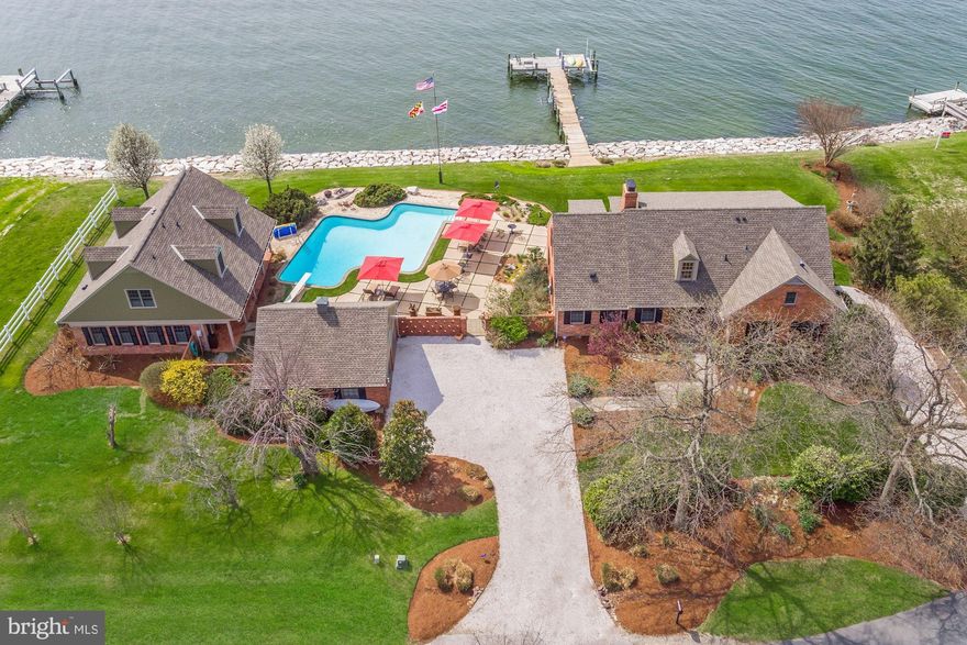 You'll spend hours  entertaining  family and friends in this Private Family retreat on the Chesapeake Bay! The property consist of a main house and guest house, a separate detached garage, pool, 200 plus feet of waterfront, pier with boat lift & jet ski lift. Many up grades included, Hardwoods, up graded kitchens,  remodeled master bath to include steam shower and soaking tub, granite counters, central vac. security & sound built in, 4 zone heating & air and so much more. The homes include separate laundry & kitchens in each house and full guest quarters in each house. First floor living is possible  with this property. Great Location 6 miles to bridge & shopping! Very special property one of a kind on the Chesapeake Bay. Nothing like a full retreat perched above the Chesapeake Bay.(This property consist of two tax records recorded  lots 307 and 309 Queens Court. Main House taxes record 1804041631 and  guest house 1804041623, Combined lots equal 1.02 acres)