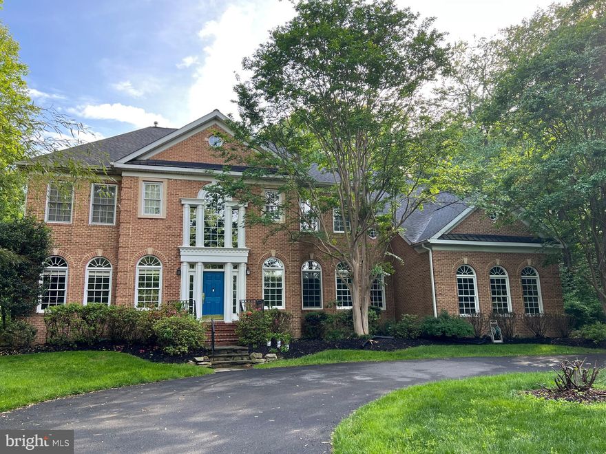 Welcome to this exquisite Custom Rembrandt Brick Colonial, with Pool, nestled on a sprawling 2.47-acre estate with seasonal river views of the Potomac. Enjoy a private setting just 6.7 miles from Potomac Village, offering both tranquility and convenience. Approach this magnificent residence via a long, tree-lined private driveway leading to a circular drive, setting the stage for the grandeur that awaits within. Spanning approximately 8,295 square feet, this home offers an impeccable blend of classic elegance and modern convenience. The 2-story entryway makes a grand impression with its curved staircase and arched windows, reflecting the home's timeless charm. The formal dining and living rooms feature crown moldings and chair rail, perfect for hosting elegant gatherings. The chef's kitchen is a culinary dream, equipped with a large island with a breakfast bar, a breakfast table, and an expansive pantry or office off the kitchen, all providing direct access to the deck for seamless indoor-outdoor living. The adjoining family room boasts a stunning floor-to-ceiling stone fireplace, creating a warm and inviting space for relaxation. The upper level is dedicated to the spacious primary suite, complete with a sitting room, two walk-in closets and a second home office. Enjoy a spa-like experience in the renovated bathroom. Additionally, there are three more generously-sized bedrooms and two full baths, providing ample space for family and guests. The fully finished walk-out lower level is a versatile space featuring a recreation room, home gym area and a full bath, offering endless possibilities for entertainment and exercise. Step outside to your private oasis, where a 40-foot in-ground POOL, a deck, and a pergola await. Enjoy outdoor dining with convenient kitchen access, gather around the firepit, or rest easy knowing you have the security of a generator. This exceptional home also includes a 3-car garage and a laundry room off the garage for added convenience. For those who enjoy exploring, the nearby Windridge and Rockland Farm Wineries offer delightful escapes, while the C & O Towpath provides opportunities for hiking and biking along the Potomac River. Additionally, the proximity to the Skye Trace Equine Conservancy adds to the area's charm and recreational offerings. Discover the perfect balance of luxury and comfort in this stunning home, designed for those who appreciate quality craftsmanship and refined living.