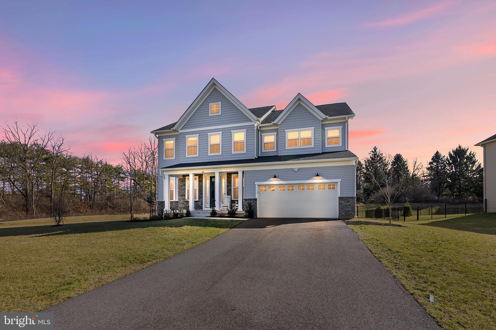 Why wait for new construction when you can move right into this stunning 2-year-old home located in the Reserve at Great Valley and the coveted Great Valley School District. With more than 5,000 square feet of living space, this beautiful 5 bedroom, 4.5 bath home offers a fabulous open floor plan and an abundance of natural light. As you pull into the driveway, you will notice the charming covered front porch which is perfect for relaxing and taking in the evening sunsets. Upon entering, take note of the beautiful natural luxury vinyl flooring and 10' ceilings, both of which continue throughout the entire main level. To the left is a large flex space, perfect for a formal Dining Room or Living Room. Continue down the hallway to a spacious Eat-In Kitchen complete with stainless steel KitchenAid appliances, custom tile backsplash, quartz countertops, custom pullout cabinet drawers, recessed lighting and pendant lighting over the large kitchen island with waterfall quartz top. The kitchen overlooks a spacious dining area which flows into the Great Room. Windows frame the space around the Great Room area offering picturesque views of the private yard and welcomes the natural setting inside the home. Continue to the convenient main floor bedroom (or possible private office suite) with ensuite full bathroom. A half bath, as well as entry to the oversized two-car garage with Tesla charger, complete the main level. Sliding doors from the Great Room lead out to a custom stone patio which overlooks the flat, fenced rear yard, perfect for entertaining and for enjoying cool nights in the space you carve out for your fire pit. The upper level consists of a very large Primary Bedroom with a spacious walk-in closet and an ensuite full bathroom boasting an oversized seamless shower. Continue down the hall where you will find three more generously sized bedrooms, each with a large walk-in closet. One of the secondary bedrooms has an ensuite bathroom, while the other two bedrooms share a Jack-and-Jill style bathroom. Completing the upper level is a very spacious laundry room with granite counters. Looking for additional living space? No problem! An open staircase from the main level leads to a large finished basement complete with the same luxury vinyl flooring used on the upper levels of the home. There is also "rough in" in the basement for an additional bathroom" A utility area and an additional storage room completes the lower-level. Convenient to shopping, restaurants, entertainment and more! Just minutes to the Chester Valley Trail, or meet neighbors and friends on the community's trail which circles the neighborhood. Easy access to major highways including Route 202, 76, and 476. Minutes from the Malvern Train station- making commuting into the City a breeze. This is a beautiful home in a wonderful community....Book your appointment today!