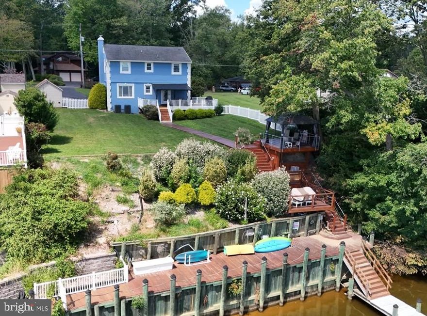 Welcome to your dream waterfront retreat at 4017 East Baker Avenue in Abingdon, MD! This charming 3-bedroom, 2.5-bathroom home offers over 2,400 square feet of beautifully designed living space and breathtaking views of the Bush River. The heart of this home is its stunning recently renovated kitchen. It features stainless steel appliances, a farmhouse sink, induction cooktop, double wall oven, microwave drawer, granite countertops, and an impressive 12-foot island. The cozy living area with a fireplace is perfect for relaxing. The upstairs primary bedroom includes a convenient en suite bathroom for your comfort and privacy. The finished lower level boasts a club room, ideal for entertaining. Step outside to enjoy your wrap-around, no-maintenance rear deck, plus upper and lower decks that lead to a 100-foot pier with 3 slips, a boat lift, and full utilities—perfect for boating enthusiasts! Additional amenities include a fenced backyard with two sheds. This home is  walking distance to the Bush River Yacht Club, and close proximity to APG , I-95, and Bel Air. Recent updates include water heater (2026), multi-zoned HVAC (2024), kitchen renovation (2023), electric fireplace (2023), LVP entire first floor (2023),  new front and back doors (2022),  new bay window ( 2021), basement carpet (2021) . No HOA and no flood insurance required! Don't miss out on this unique waterfront property!