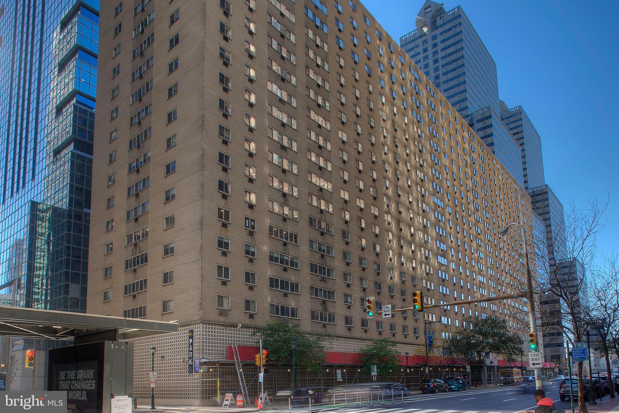 This two-bedroom co-op home in the Rittenhouse Square neighborhood is available for immediate occupancy. It is a north facing unit on the penthouse floor at Penn Center House that has hardwood floors throughout, lots of windows with great light, lofty ceilings, and large-scale rooms. The entry vestibule has a large coat/storage closet. The vestibule opens onto a spacious living room with a dining alcove and an enclosed kitchen. The kitchen has a suite of modern GE appliances and an abundance of cabinet storage. The primary bedroom is a large, elongated room with a wall shelving unit and a large walk-in closet. The room is large enough for home office space or reading nook. The hall bathroom has pretty pale-yellow ceramic tile and newer toilet and vanity. There is an oversized mirror with bright surround lighting strips. The tub shower has a double glass door. The other bedroom has a triple closet with floor to ceiling doors and space for hanging clothes and shelves. There is a laundry area with hookups for a washer and dryer, a linen closet, and built-in cabinets over the machine area. This unit has a great deal of storage space. The monthly co-op fee includes heat, air conditioning, electric, water, basic cable, real estate taxes and building maintenance services. The building has 24-hour security and a concierge, 24-hour maintenance staff, management office, fitness center, community room with a kitchen, library, roof-top deck, guest suite and common laundry room. The fitness center has an annual fee of just $125. There is an on-site parking garage available for $145 per month, which is one of the best deals in the city. Penn Center House is located several blocks off Rittenhouse Square, which has some of the best restaurants, shopping, and nightlife in the city. The park has a farmer’s market twice a week and hosts arts & crafts shows and festivals throughout the year. Trader’s Joes in a block away, DiBruno Brothers specialty market is three blocks and Giant is four blocks. There are many public transportation options right outside the building. The suburban train station is a block from the building and 30th Street Station is a short stroll down JFK boulevard. There are also multiple bus routes within a block of the building. The Schuykill River Trail, museums, University of Pennsylvania, Drexel University and Children’s Hospital are all within easy walking distance.