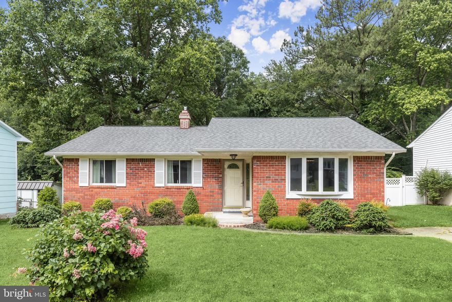 Welcome to this charming rancher-style home in the desirable Rippling Estates community of Glen Burnie! This home offers an inviting open floor plan, perfect for modern living and entertaining. The dining room features vinyl flooring and a stunning vaulted ceiling, creating an airy and spacious feel. In the living room, you'll find beautiful hardwood floors, a neutral color palette, and built-in cabinetry, providing both style and functionality. The kitchen is equipped with ample storage, electric cooking, and sleek appliances. The seamless flooring extends into the living and dining rooms, enhancing the open-concept design.  The spacious primary bedroom is serene and complete with an ensuite bathroom that includes a modern walk-in shower. Two additional bedrooms and a hall bath complete the sleeping quarters, offering comfort and convenience for family or guests. The lower level family room features a half bath, a wet bar, and massive storage, making it a perfect space for relaxation and entertainment.  Outside, the driveway provides ample parking space. The deck and patio are perfect for outdoor living and entertaining, with views of the beautifully landscaped grounds and a serene wooded area. Conveniently located near major commuter routes including MD-3, MD-100, and I-97, this home makes commuting a breeze.  Don't miss out on this wonderful opportunity to own a home in the Rippling Estates community! Schedule a tour today and experience the perfect blend of comfort, style, and convenience.