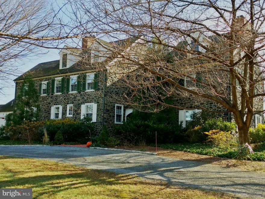 Click on the Video to tour this very rare combination of Historic 5 BR, 4   BA stone PA farmhouse on a hill away from the road. Close to Wilmington, the graceful gated drive leads through the 5 fenced acres featuring woods, stream and pond creating a quiet country retreat of nearly 7 acres. Extensive replacement of major systems (generator, propane, water filtration) with 3 car garage, a tack room and car shed, raised bed herb & vegetable gardens. The inviting recessed front door and 2 story, brick floored entry with wrap around gallery make for the perfect place for art / collections.  A gracious formal living room offers high ceilings, beautiful moldings and deep window-sills on 3 sides plus a lovely fireplace with antique mantle. Glass French doors close off the gracious dining room built for elegant entertaining.  The adjoining glass walled Family Room features an exposed stone wall, built-in TV corner cupboard and barn beam shelving.  The updated white country kitchen with a massive stone fireplace and new stainless appliances compliments the white Wood Mode cabinetry in keeping with the style of this special house.  A very useful butler's pantry / wet bar, mudroom and new laundry room addition enhance this area.  The light filled MBR includes a walk-in closet and new tumbled marbled bath.  A guest room, hall bath and a 2nd MBR with whirlpool bath complete the second floor.  The surprising 3rd floor has 2 bedroom areas and full bath.  Stretching along the back is a fabulous slate terrace for entertaining a la Tuscany.  Horses and animals are all allowed and there is plenty of room for a pool and barn.
