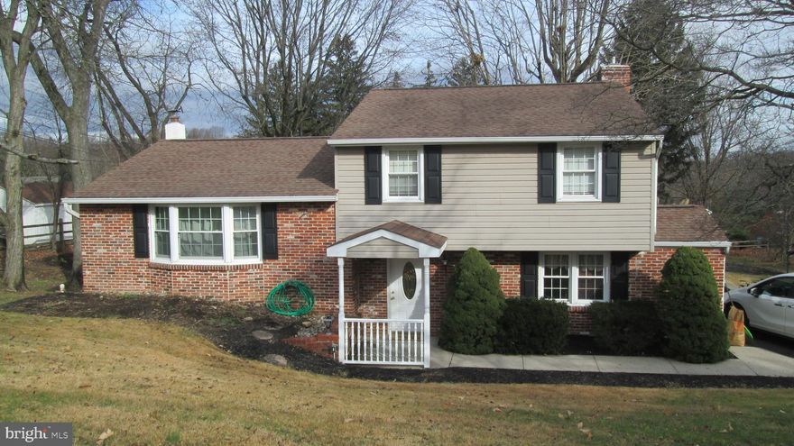 Welcome to 73 Witherington Drive, located in desirable Witherington Heights in beautiful Holland. A  covered porch entrance  leads into a nicely sized foyer and  large family room, 19x15  with a propane gas fireplace with heater, half bath,  and sliding glass doors with scenic view of the rear covered patio and wooded backyard, & laminated wood floor. There is an  adjacent room with a full bar & 4 pub stools next to the  family room that is perfect for entertaining & watching the Eagles!  Stairs lead into a spacious 21x12  kitchen/dining room combination, window with view of the back yard. The l9x14 iving room has hand scraped birch flooring and large windows overlooking the large front yard. Upstairs the hardwood flooring continues into the 3 bedrooms. The hall bath and attic for storage are also on this floor.  The finished basement is steps down from the family room and is heated, with laundry room & outside exit door to the back yard. Oil tank is in closet in basement as are the  Boiler (replaced 2012), A/C (replaced 2012), Water Heater (replaced 2019) are in the basement closets. The back patio & covered porch with fan & skylight is a wonderful place to sit & read or entertain while enjoying the peaceful back yard & wonderful view. There is a half garage, 11x9, for storage along with the attic and shed in the back yard. Both chimneys have new stucco &  new liner (2023).   Large driveway easily fits 4 or more cars. The neighborhood is walkable with only 1 entrance in/out of this development, the house sits at the end of a cul de sac. Quiet, secluded, a little slice of heaven!