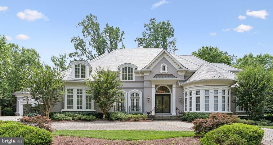 FANTASTIC NEW PRICE! Set on a premium .71 acre lot overlooking the scenic preserve in the quiet gated community of Rapley Preserve at Avenel, this custom oasis elevates the concept of luxury living to an entirely new level.  Extensive 2023 renovations include a NEW slate roof, NEW wide plank white oak hardwood floors, NEW upper level bedrooms and baths along with numerous systems and more. Two story arched windows flood the home with natural light while plaster crown moldings and hand-crafted scrolled ironwork set the tone of refined elegance that begins at the custom front door and extends through all three levels. 5 bedroom suites include a main level primary, 3 upper level suites and 1 on the lower. The main level features a handsome paneled library with curved wall of windows and fireplace, beautiful formal dining room with hand-painted wallpaper, living room defined by a stunning floor-to-ceiling palladian window, and formal and informal powder rooms.  The kitchen is every chef’s dream, appointed with vaulted, beamed wood ceiling, limestone ceramic floors, and substantial island. The open concept kitchen/family room offers a sunlit casual dining area overlooking the grounds and family room enhanced with built-ins and one of the home’s 5 fireplaces.  Every fireplace is dual fuel, operable as wood burning or gas. Sited for privacy at the opposite end of the main level, the primary suite overlooks the lush backyard and features three jaw-dropping professionally organized walk-in closets including  a custom dressing room, gorgeous bath with octagonal tray ceiling, and an additional room perfect for a second home office. A work of art itself, the dramatic scrolled stair banister to the upper level, one of two staircases, leads to 3 additional ensuite bedrooms, each with a renovated bath and generous closet space. The sprawling lower level introduces a host of entertaining, play and exercise areas, 2 fireplaces, bedroom 5 with ensuite bath plus a separate half bath and wide walk up staircase to the backyard.  Are you in need of abundant storage space? You found it along it with multiple zoned heat and cooling, a reverse osmosis water system with UV filtration, and 4 garage spaces tucked discreetly to the side of the property.  The peaceful rear yard features a flagstone patio with multiple seating and dining areas overlooking meticulous landscaping with room for a pool. Centered around the professional TPC golf course of Potomac, Avenel includes three swimming pools, a clubhouse, tennis and pickleball courts, ball fields, playgrounds, and a three-mile jogging and biking trail. Many homes in the community have private pools, and this property presents that option to the new owner as well.  HOA includes all lawn care, offering  a turn-key luxury lifestyle.