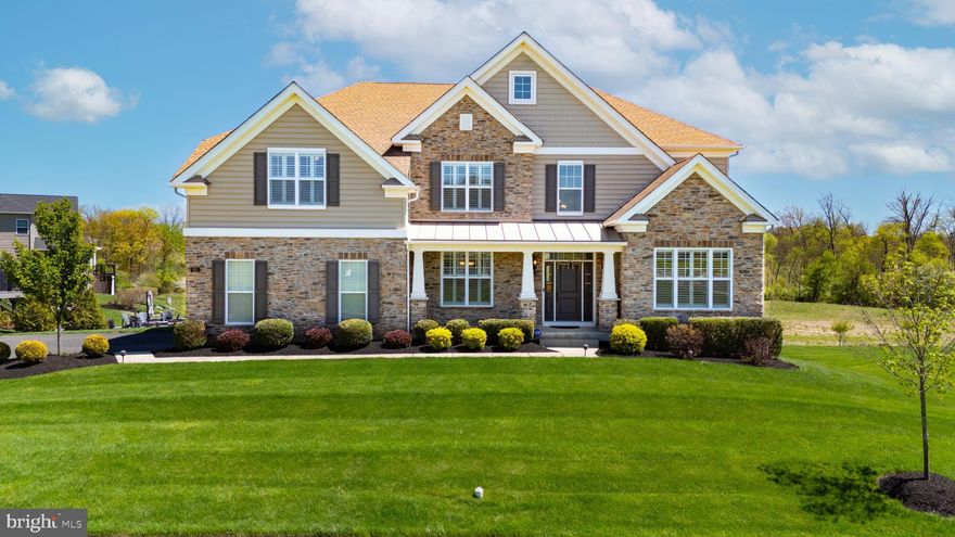 Welcome to 311 Kate Way in the prestigious Parkview at Warrington community, built by Toll Brothers in 2019 and located within the award-winning Central Bucks School District. A premium lot location in back of the neighborhood backing to open land. Ideally situated within walking distance to Nike Park, Lions Pride Park, and Warrington Soccer Club fields, this 5-bedroom, 4 full bath home offers 4,300+ square feet of thoughtfully designed living space. The exterior showcases a refined blend of stone, cedar shake, and premium siding, complemented by a covered front porch, manicured landscaping, accent lighting, and a full irrigation system. Out back, an elevated Trex deck overlooks a private, natural setting and is loaded with upgrades including illuminated steps and post caps, a covered pergola with ceiling fan and outdoor TV, and a decorative privacy screen—perfect for entertaining. Inside, a dramatic two-story foyer with hardwood flooring and detailed millwork opens to formal living and dining rooms with wainscoting and crown molding. The home features hardwood flooring and 9’+ ceilings throughout, leading into a stunning two-story great room with a gas fireplace and oversized windows. The gourmet kitchen is equally impressive with granite countertops, stainless steel appliances including a double wall oven and 6-burner cooktop, tile backsplash, Bluetooth speaker system, and two large walk-in pantries. A main-level in-law suite with full bath adds flexibility, while the laundry room offers a rare side-entry staircase from the driveway. Upstairs, the primary suite is a true retreat with tray ceilings, a versatile bonus room, dual custom walk-in closets, and a spa-like bath with soaking tub, dual-head shower, and double vanity. Two guest bedrooms share a hall bath, while a third features its own en-suite. Additional highlights include plantation shutters throughout, a walkout basement with upgraded ceiling height, dual-zone HVAC, electric vehicle charger, and hardwired exterior security cameras. This exceptional home blends luxury, function, and location in one of Warrington’s most desirable communities. Serviced by Mill Creek Elementary, Unami Middle School, and Central Bucks South HS.  Select photos have been virtually enhanced to illustrate potential layouts and views. There are security cameras on the premises so please be aware of that.