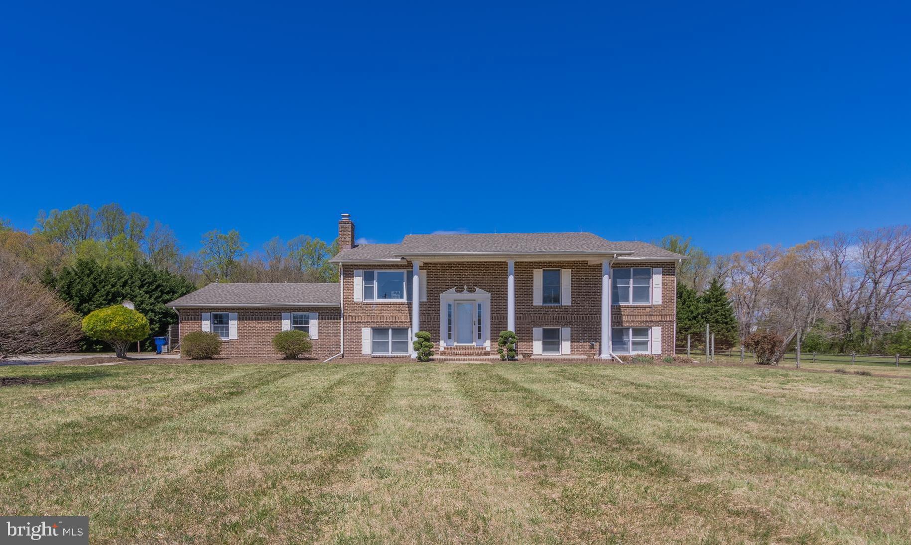 Beautiful brick front home on 4 acres cleared and level for your recreational enjoyment! 4 bedrooms and 3 full baths, attached two car garage and detached barn/workshop with loft and electric connected! Upper level family room and separate dining room. The kitchen has cherry cabinets, granite countertops. Lower level has an additional family room with wood burning fireplace, full bath and 4th bedroom. Large composite deck has access from the kitchen and master bedroom. Concrete patio under deck. Partially fenced in back yard. Recent updates to include a brand new roof and renovated Master bath and hall bath. Gorgeous property in a great location!