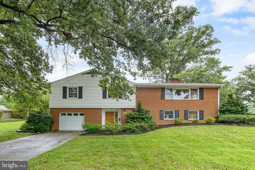 WEST SPRINGFIELD - 4BR/2.5BA, Updated & Overlooks Parkland! This delightful home has been freshly painted, and boasts gleaming hardwood floors on the main level, and large windows and spacious rooms throughout. From the living room's picture window, you can enjoy a view of the wooded parkland across the boulevard. The built-in shelving and wood-burning fireplace contribute to this inviting space. In the dining room, you'll find built-ins and sliding doors that lead to the brick patio and partially fenced backyard. The updated kitchen boasts ample solid wood cabinets and counter space. The main level also offers four bedrooms, including a primary bedroom with an ensuite bathroom, and an additional hall bathroom. The lower level features a generously sized family room with new flooring, a wood-burning fireplace, and a cozy sitting area. There is plenty of space for a game table, home office, or more! A half bathroom, laundry room, an attached 1-car garage, and abundant storage space complete this level. Conveniently located near grocery stores such as Whole Foods, Trader Joe's, and Giant, as well as the shopping, dining, and entertainment options at Springfield Towne Center. Just one block to the bus stop and easy access to commuter routes (Rts 395/495/95).  Don't miss out on the opportunity to make this charming Springfield home your own!