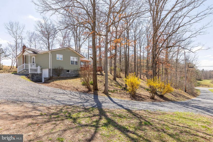 COUNTRY KING....ADORABLE RENOVATED RAISED RAMBLER ON 3.6 UNRESTRICTED ACRES OF BEAUTIFUL LAND IN SUPER CONVENIENT LOCATION. NEW EVERYTHING....ROOF, SIDING, PLUMBING, HVAC, FLOORING, PAINT, APPLIANCES.....NO FEARS OF UNEXPECTED REPAIRS UPON PURCHASE WHEN EVERYTHING IS NEW. WORK FROM HOME WITH FRONTIER FIBER INTERNET! DECK & COVERED CARPORT PROVIDE GREAT OUTDOOR LIVING SPACE TO ENJOY THE VIEWS OF ADJACENT FARMS. ABSOLUTELY GORGEOUS PIECE OF LAND....HOUSE IS TUCKED AWAY PRIVATELY ON A WOODED RIDGE WITH STREAM FLOWING ALONG THE EDGE OF THE PROPERTY, ABOUT 1/2 ACRE OF YARD/PASTURE FOR SMALL LIVESTOCK OR CHICKENS AND ENOUGH SPACE FOR A LITTLE HUNTING & SHOOTING. NICE WORKSHOP/SHED WITH LEAN-TO FOR EQUIPMENT. THIS HOME'S BEST ATTRIBUTE MAY BE IT'S LOCATION....JUST OFF THE PAVED ROAD AND WITHIN 1 MILE OF GAS STATION, POST OFFICE, RESTAURANT, DOLLAR GENERAL AND BRAND NEW ELEMENTARY SCHOOL....THAT'S WHAT YOU CALL COUNTRY CONVENIENCE! EASY 30-35 MINUTE DRIVE TO WINCHESTER, VA FOR COMMUTERS. IT SEEMS LIKE 300K DOESN'T GET YOU MUCH THESE DAYS BUT YOU'RE GETTING YOUR MONIES WORTH HERE! COMPLETELY RENOVATED HOME, 3.6 ACRES OF AWESOME UNRESTRICTED LAND AND A LOCATION THAT'S TOUGH TO BEAT....COUNTRY LIVING AT ITS FINEST!