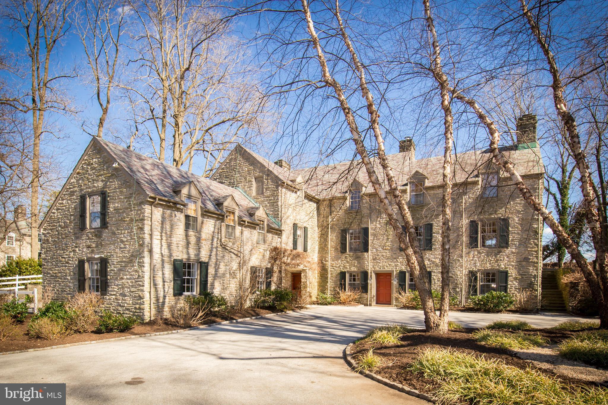 This gorgeous, elegant 1938 stone Colonial Revival is a home to fall in love with! Beautifully decorated in luxe textures and bathed in lovely natural light, it offers all the space and amenities you want but in a manageable size. Designed by noted architects, Tilden & Pepper, it has many distinctive period details including random-width, pegged oak floors, deep window sills, arched doorways, a slate roof, and beautiful stonework. The current owners have made significant improvements while respecting the home's architectural integrity. The updated kitchen has a Viking stove and other stainless steel appliances, soapstone counters, a center island, large pantry, and a slate floor. The beautiful master suite has a dressing room and a renovated bath with custom vanity and stall shower with penny tile. Enter via a lovely reception room with slate floor. Also on this level are a large family room (great for entertaining), a powder room, laundry, exercise/storage room, and utility room. On the main level are a gorgeous living room, wood-paneled den, and formal dining room, all with wood-burning fireplaces, a powder room, kitchen, and butler's pantry. Down the hall from the kitchen is the original servant's wing with 3 rooms and a full bath, offering many options: office space, a guest or au pair suite. The dining room is pure French romance, with Zuber scenic wallpaper and wall panels hand-painted by a local artist. On the upper floor are all four main bedrooms and three full baths. The grounds are stunning, with many specimen trees, hydrangeas and perennials, and a circular driveway leading through an archway to a courtyard and 3-car garage. The location is so convenient, steps from the Cricket Club, SCH Academy, and the Wissahickon Park, and a 10-minute walk to the train to Center City.