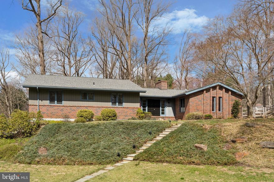 Welcome to 13 Hunters Lane. This beautifully designed 4-bedroom, 2.5-bath mid-century home is quietly situated on a cul de sac street, and offers the perfect blend of updated indoor spaces and serene outdoor beauty to enjoy year-round.  This charming retreat is located in the picturesque town of Chadds Ford, Pennsylvania. 

Step inside to discover original parquet floors, and then a spacious living room, where large windows flood the space with natural light. Original beams, a floor to ceiling brick fireplace and thoughtful design details create an inviting space to gather. The thoughtfully re-designed kitchen, complete with new countertops, appliances, backsplash, lighting, an enlarged central island and more, is perfect for both everyday meals and entertaining. Just off the kitchen, the dining area provides a cozy gathering space with a unique built-in and direct access to the screened-in porch, offering a seamless connection to the outdoors.  

The screened-in porch serves as an ideal spot to enjoy the beauty of nature while being protected from the elements. Whether sipping morning coffee, unwinding with a book, or hosting guests, this space highlights the serene sounds and views of nature that surround this home.

The primary suite offers a private retreat, featuring a generously sized bedroom flooded with natural light and beautiful views, a full en-suite bath, and a walk-in closet. There are two additional main-level bedrooms with generous closet space, and a full hall bath with a large stall shower. Original mid-century details, exposed beams and original trim highlight the quality and integrity of the home. 

The daylight lower level is a standout feature, boasting a spacious family room with a wood stove. Large windows bring in natural light and showcase the beauty of the backyard. Conveniently located next to the family room, is an updated half bath and laundry room, as well as access to the back yard. There is also a versatile fourth bedroom on the lower level, perfect for a multitude of uses such as an at home office, guest suite, au pair quarters, or creative studio. 

Outside, the lush backyard offers a tranquil escape, with mature trees and open space to enjoy nature. The outdoor areas feel secluded yet expansive, and provide endless opportunities for relaxation and recreation.  This home features many unique features and upgrades such as a new roof in 2020, newer HVAC systems, upgraded water treatment systems, updated baths, kitchen, flooring and much more! And for your convenience, should the power go out, an automatic built-in generator will keep you warm in the winter and cool in the summer. There is even an electric dumbwaiter adjacent to the oversized two car garage that will effortlessly hoist up your groceries and goods to the main level with the push of a button. There have been many upgrades to this lovely home, and you will be surprised at how much storage is available in many thoughtful places throughout.

Tucked away on a cul de sac, yet incredibly accessible to major routes, and amenities, 13 Hunters Lane offers the perfect balance of comfort, convenience, and natural beauty. Homes like this don’t often become available— make your appointment today to secure your opportunity to be the next owner of this beautiful property.