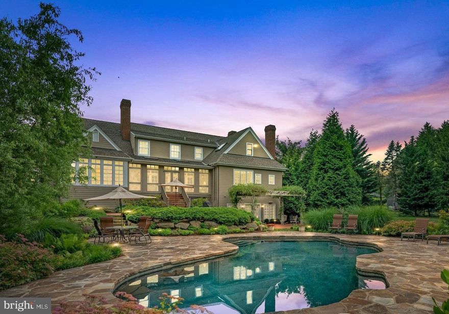Nestled on nearly two-acre , 1267 Valley Road is a masterpiece designed by architects William Poole and Scott McIntyre of McIntyre Capron & Associates, in collaboration with the owners. This Virginia Farmhouse style home offers luxury and tranquility, which has evolved over 25 years into a mini estate of unparalleled beauty. Approaching along a private cobblestone edged driveway, bordered by mature trees, the farmhouse porch welcomes with mahogany floors and a copper roof, a perfect spot for relaxing with a morning coffee or evening glass of wine. 

Inside, a grand two-story foyer features a custom staircase with white risers and cherry treads, showcasing impeccable craftsmanship and custom millwork throughout the home. Flanking the foyer on either side are two distinct and inviting spaces. To one side, a spacious living room with grand fireplace, is  perfect for both intimate gatherings and relaxed evenings. On the opposite side, the traditional dining room exudes charm, ready to host formal dinners and festive celebrations. The kitchen, adorned with Kountry Kraft white custom cabinetry (renowned for their high-quality, environmentally conscious products made in the USA), combines traditional style with modern amenities like a farmhouse sink, Wolf stove with eight burners, Sub-Zero refrigerator, and a butcher block island. A spacious walk-in pantry and breakfast room with tray ceiling and wall to wall picture windows with pool views enhance the culinary and dining experiences. This bright and airy room provides easy access to the three-season porch, which in turn leads to one of the home's charming terraces. The back hallway, with its elegant slate flooring, leads to an additional front door opening onto a smaller, charming porch. This hallway also provides access to the back staircase and the garage. Off the hallway is a spacious laundry room, mirroring the kitchen's high-quality cabinetry. It features a generously sized sink, Miele washer and dryer, and a convenient bath/shower, perfect for bathing pets or rinsing off muddy boots. This level also has an additional living space with fireplace, just off the kitchen with French doors opening to the 3 season porch. 
The main floor includes a luxurious primary bedroom with sitting area, two walk-in closets, and an ensuite bathroom with dual vanities, steam shower, and whirlpool bath. Upstairs, two climate-controlled suites offer privacy, one with an additional bedroom, while two more bedrooms share a hall bathroom. The lower level features wide plank cherry floors, a gym, state-of-the-art theater, custom bar, billiard area, wood-burning fireplace, and French doors to a terrace.
Outside, landscape architect Doug Mecray's design integrates natural stone elements, including a boulder retaining wall, antique brick paver patios and multi-level terraces with limestone slab steps. The use of Pennsylvania fieldstone provides a natural backdrop around the custom-designed, free-form pool, which mimics the look of a pond and is finished with upgraded Pebble Tec Stone for a dark blue water effect. A pool house, reminiscent of a historic "smoke house" features large exposed timbers & shiplap siding, metal roof, an oversized masonry fireplace with a barn beam mantle, built-in refrigerator, copper sink, and TV/internet wiring. Meticulously maintained gardens and lawn terraces surround the property, offering a private oasis bordered by natural beauty. The sellers eagerly await passing this exceptional property to new homeowners ready to embrace its rich history and unparalleled living experience. Whether relaxing in tranquil gardens, hosting by the pool, or enjoying the craftsmanship within, 1267 Valley Road offers a unique opportunity to live amidst elegance and serenity. This home is convenient to major interstates,  30 minutes to Philadelphia International Airport &. less than 20 minutes away to the Mainline. Close to restaurants, all your shopping needs including tax free shopping in DE .