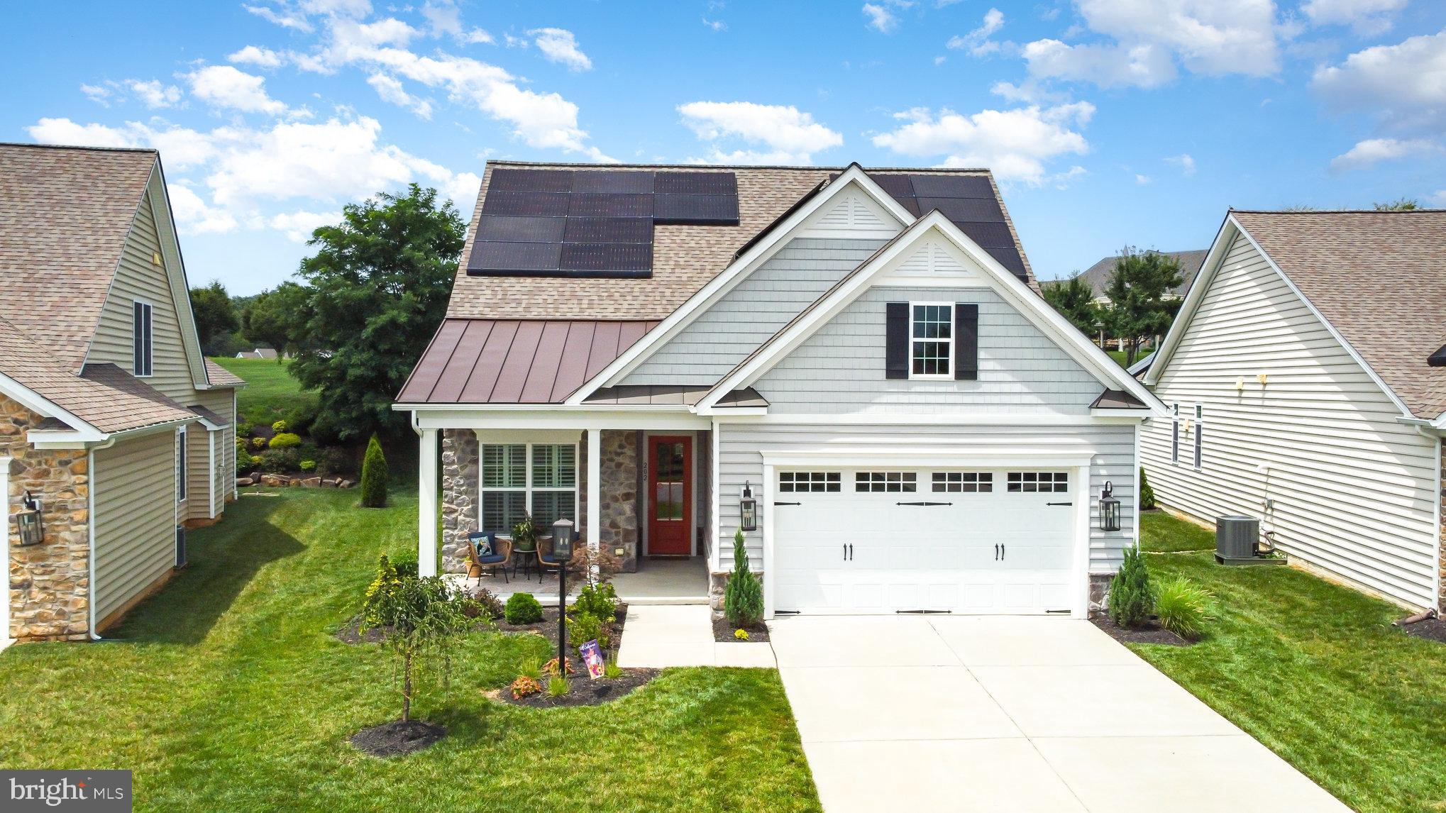 Nestled in the highly desirable resort-style community of Bulle Rock, this 3 year young Trademark Custom Homes Magnolia model (w/upper level) is sure to impress! Offering 3 bedrooms and 3 full baths on 2 levels, this stunning residence was designed for one level living with a zero threshold entry from the garage. Owned solar panels have resulted in NO UTILITY BILLS (a once a year small refund from BGE). A chef's kitchen features: a 10'3" Cambria quartz waterfall island and backsplash, walk-in pantry w/closet organizers, Samsung stainless steel appliances, induction cooktop with a single door double oven, hard-wired undermount lighting, stylish sage green cabinetry, water filter at the sink, refrigerator w/inside door water dispenser that filters into a pitcher,freezer dispenses 2 sizes of ice, pendant and recessed lighting and a stunning coffered ceiling. The great room features a gas fireplace, mantel and a chevron pattern shiplap surround. An open floor plan filled with sunlight, showcasing plantation shutters throughout and a separate dining room that leads to a 4 season sunroom. The versatile sunroom features lantern sconces, wainscotting, custom blinds and opens to the rear maintenance free deck. The main level primary suite overlooks the lovely landscaped rear lawn, the adjoining bath has a walk-in shower w/bench seating....and the walk-in closet-Extensive custom closet organization system, deep storage, thoughtfully designed with different size drawers and adjustable shelves. There is a second main level bedroom with a walk-in closet (also with a closet organization system). Another full bath can be found on the main level. The upper level has a bonus room/flex space, addtional bedroom and full bath. The main level laundry room is spacious and features a front-loading washer and dryer, abundance of cabinetry, a sink and a walk-in storage closet. There is no shortage of storage in this home. The garage offers a storage nook, mounted overhead storage, pre-wired for 1 EV and 1 hybrid vehichle and has its own heat/cooling system. Neutral color pallet throughout, wide plank LVP flooring and custom window treatments. Enjoy refined living in one of the areas most sought after neighborhoods. Enjoy the 37,000 sq ft Residents' Club offering more activities than you can imagine, a fitness center w/new equipment, billard, card and meeting rooms, indoor and outdoor pools, pickleball and bocce ball court and more. Bulle Rock is a gated golf course community where golf membership is available and discounted for residents. Close proximity to downtown Havre de Grace, where the Susquehanna River meets the Chesapeake Bay. Enjoy shopping, dining and a vibrant arts community.