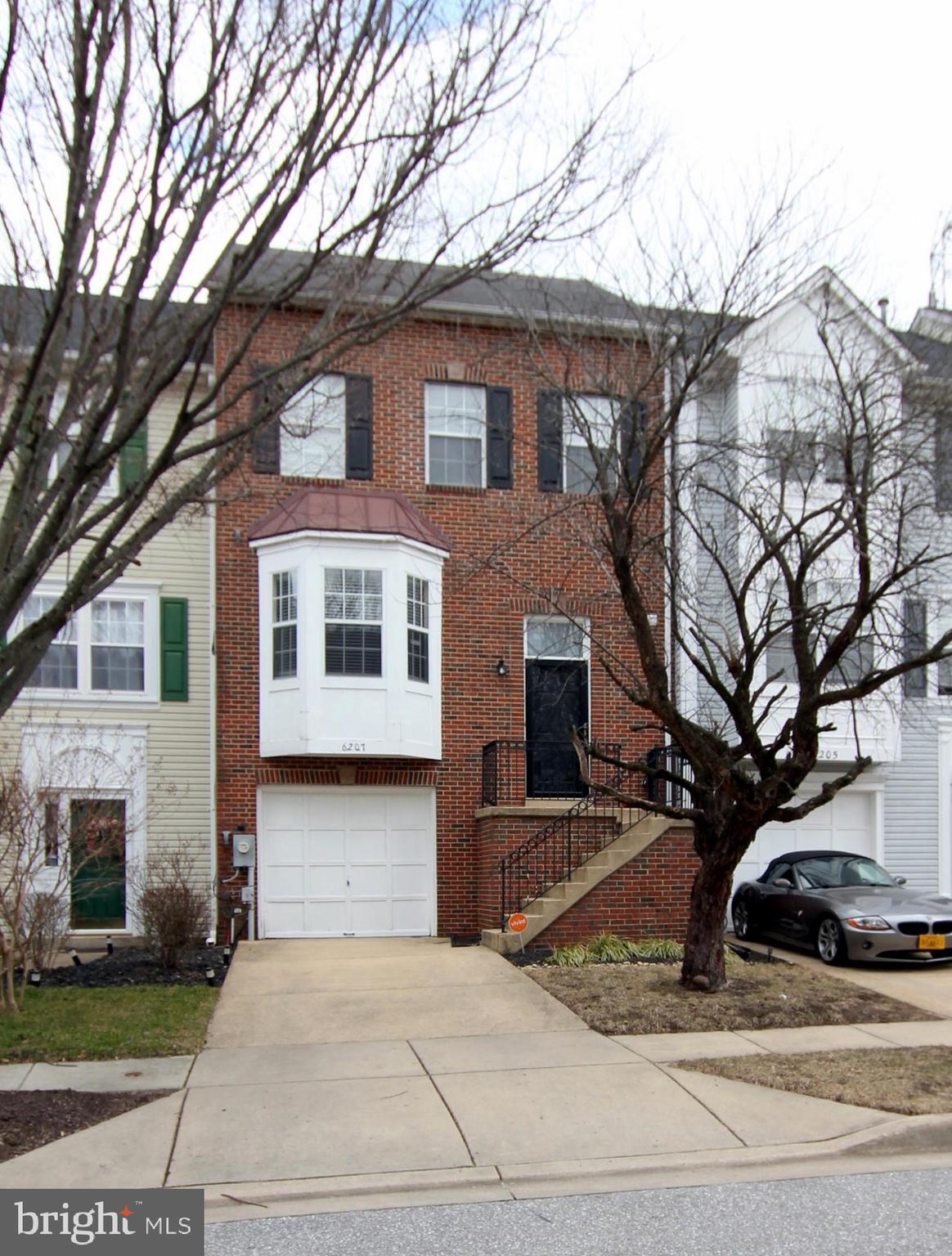 Brick-front garage townhome with finished lower level and deck. The main living level is the mid-level comprised of a sunny, table space kitchen facing the street with bow window and a gracious dining room/living room in the back with a pass-through window from the kitchen, decorative columns, hardwood floors and sliding glass doors out to the deck in back. The bedrooms are on the upper level with the primary bedroom having a custom walk-in closet and soaring ceiling with a loft that can be used as your own person get-a-way space, exercise studio or home office. The en-suite bath has a separate shower and soaking tub. This home is priced-to-sell! Don't wait to make an offer or you will surely miss it.