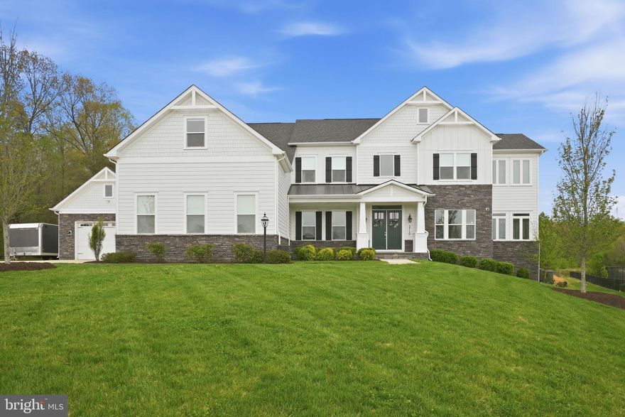 Welcome to an extraordinary private retreat offering over 8,000 square feet of architecturally stunning and designer-influenced beauty on a premier 2+ acre cul-de-sac lot backing to both the golf course and protected woods, creating a rare blend of scenic beauty and privacy. You will quickly notice that this home is very different in all of the wonderful ways - throughout their ownership, the current owners have invested over $600,000 in upgrades, elevating both style and performance across the home. Inside, the home immediately impresses with thoughtful design and luxury finishes throughout. The chef’s kitchen is truly the heart of the home, featuring an oversized island, quartz countertops, a professional-grade 6-burner stove, and custom high-end cabinetry, making it equally suited for everyday living or hosting unforgettable gatherings. The adjoining family room showcases architecturally stunning ceilings with custom beams and wood inlay, anchored by a dramatic stacked stone gas fireplace, creating a warm and inviting centerpiece. The main level offers exceptional functionality, including two half bathrooms for maximum convenience and seamless entertaining. The primary suite is TRULY a private retreat—designed to feel like its own luxury apartment. This expansive space features a private sitting room with built-ins and a wet bar, a personal gym, and a spa-inspired bathroom with a multi-jet walkthrough shower. The cavernous walk-in closet with custom organization provides exceptional storage and maximizes functionality. Upstairs, you’ll also find three extremely generous secondary bedrooms, including one ensuite and two connected by a Jack-and-Jill bathroom, along with a reimagined design-inspired laundry room that combines beauty and functionality. The fully finished lower level offers exceptional flexibility and entertainment options, including a massive recreation room, a professionally installed theater room with raised seating, and a private nanny or in-law suite complete with a full bathroom and sitting area, providing comfort and privacy for guests or extended family. Step outside to experience another amazing highlight of this home—the stunning outdoor living spaces and serene natural surroundings. The oversized maintenance-free deck overlooks the golf course and wooded backdrop, while the covered lower-level entertaining area features wood inlay ceilings, retractable screens, and a custom glare-free TV, creating the ultimate year-round multi-faceted gathering space. With direct access to nearby trails, outdoor enthusiasts will appreciate the easy connection to nature for walking, running, or recreational adventures. Car enthusiasts and hobbyists will be thrilled by the rare 5-car garage configuration, including a 3-car attached garage equipped with custom cabinetry, Swisstrax flooring, slat-wall storage, retractable ceiling platforms, and added insulated attic storage, along with a temperature-controlled 2-car detached garage with mini-split system—ideal for off-road vehicles, recreational gear, or specialized workspace needs. This exceptional property offers the perfect balance of luxury, privacy, functionality, and lifestyle—an opportunity that is truly rare in an ideal, sought-after Davidsonville community. You absolutely have to see this home to appreciate its uniqueness, beauty and incredible attention to detail!!