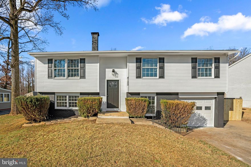 Welcome to 4122 Tiverton Rd! Nestled in the Sought after community of the woodlands in Randallstown. Stunning  4 Bedroom 2 Full bathroom Split Foyer home with attached garage .  The main level offers an open living/dining room with exposed beams and vaulted ceilings. All new luxury vinyl plank floors throughout. Gorgeous kitchen with SS appliances, quartz countertops, island with additional seating, new cabinets and tile backsplash. There are two sliders one off the kitchen and  the primary bedroom that lead to the expansive new wood deck.  Upstairs you'll find 3 spacious bedrooms and 2 full bathrooms. The primary bedroom offers an en-suite bathroom. Make your way downstairs where you'll find a half bathroom, fully finished large rec room and laundry. Additional updates include a brand new roof, freshly painted throughout, new light fixtures. Schedule your showing today before it's gone!