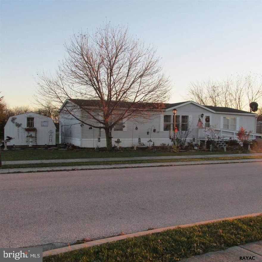 Adorable one level living with handicap ramp access.  Clean and neat.  Situated with no home behind it and none can be built. Large covered porch for warm summer days. Shed for storage. Nice size rooms easy living. Large kitchen with laundry.  Peninsula in kitchen and gas range.  Beautiful landscaping.  Great lot in this community.