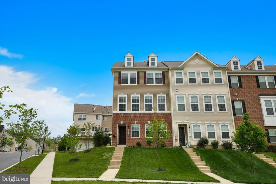 Largest northeast facing end unit town home lot in much sought after Rockland at Rogers community. Beautiful brick front and excellent front view. Year round sunlight in house. Upgrades include top of the line kitchen appliances and cabinets w/ nicely done back splash. Fully upgraded master bath w/ walk-in closet. Features include office, fireplace, & deck. Lower level has rec room & powder room.