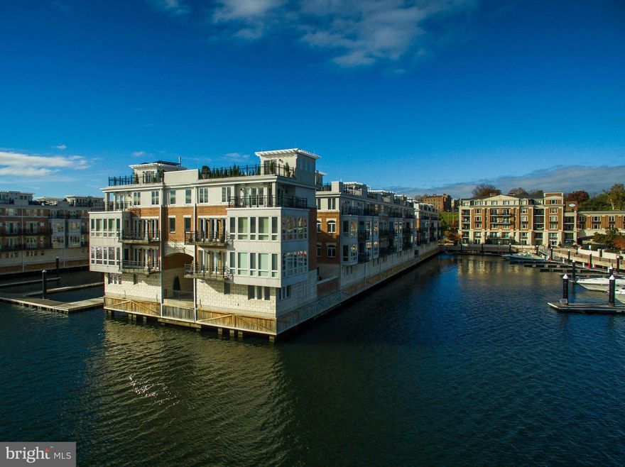 MAGNIFICENT MANSION ON THE WATER: Unprecedented in proportion and grandeur, this 9,000+ sf Pier Home offers 5 lvls, 6 BD, 7 BA, 3 half baths w a sophisticated living experience rarely available in Baltimore's exclusive gated community. This residence features many lavish upgrades, Elevator, Sauna, Home Theater, Multiple Verandas, Rooftop Terrace overlooking the Inner Harbor & 4 car garage.