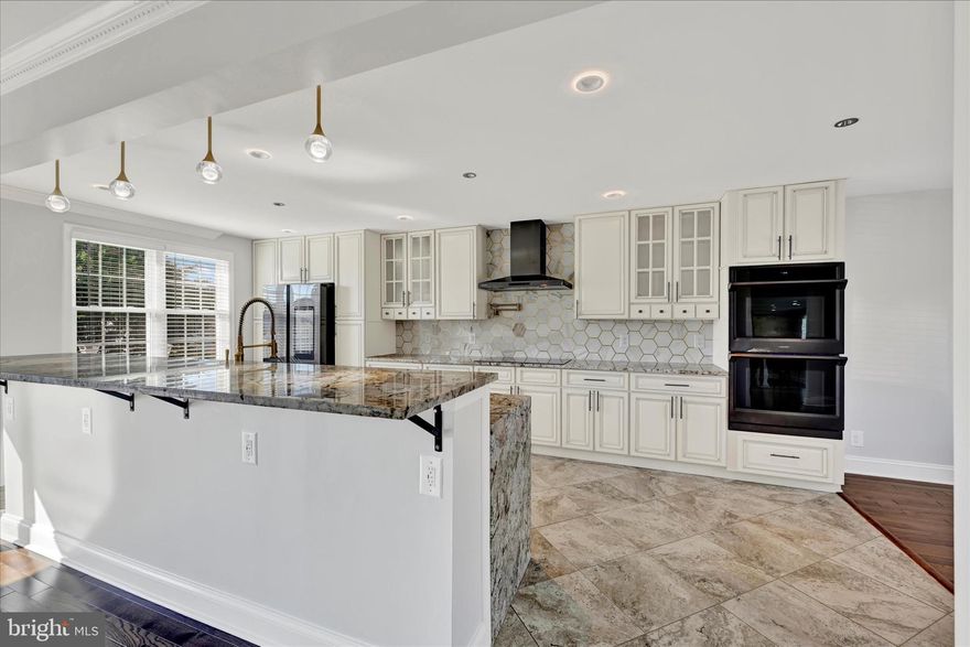 You've seen the phrase & wondered, "but, really"? And yes, THIS is a show stopper! From the space to the colors to the QUALITY materials, this 3BR/4BA ALL BRICK beauty WILL amaze you! What to notice first? Maybe the upgraded one year old hardwoods or the soft, modern colors. The kitchen? WOW! Huge & no expense spared. You'll find beautiful 42" cabinetry, a chic marble backsplash, gorgeous granite counters w/waterfall edging, SS smart appliances & multiple areas to dine. The family room is quite welcoming with a striking stone wall surrounding a wood-burning FP. Continue on into a large adjacent den/bonus room which will lead you out onto a fabulous rear deck. More on that later. This level also features the much desired flrst floor laundry as well as one of 4 luxurious, upgraded baths.  Upstairs, you'll find the primary suite along with 2 additional bedrooms, all featuring Asian walnut floors. The primary suite is generously sized with a step-down sitting area & a stunningly renovated primary bath featuring even more beautiful cabinetry, dual sinks, a glass enclosed walk-in shower, free-standing soaking tub & a 23' long walk-in closet!  The hall bath on this level is equally updated & amazing. Travel down to the lowest level & you'll find a large rec room area with ceramic tile flooring & a built-in bar. From here, you can also access the oversized 2 car garage. Finally, there is much to enjoy outside incl a very large trex deck, custom inset hot tub area, patio already equipped with electric for a future outdoor kitchen, vinyl privacy fencing & a retractable awning. The grounds are also outfitted with a front & rear irrigation system. I could very much go on & on! Come see for yourself that it feels good to be HOME!
