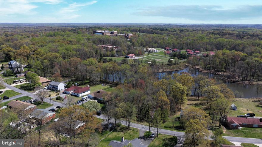 Perfectly positioned in the heart of Prince George’s County, this 0.52-acre residential property offers a rare blend of waterfront serenity and unmatched convenience.

-Waterfront (70 feet of Shoreline!)
-All Utilities (Power, Water, Sewer)
-Easy Access w/Paved Road Frontage
-Very Buildable: Flat & Floodplain-free Homesite Area
-Platted
-Goldilocks Location Midway between Washington DC and Baltimore
-Lowest-Priced Waterfront Lot in the Market!

With approximately 70 feet of shoreline along a peaceful, fishable, U.S. government-owned pond, the setting provides a quiet, natural backdrop that feels far removed from the rush of city life.

The property is fully equipped with all utilities—power, water, and sewer—available along the 90 feet of paved frontage on Ellington Drive, making your path to building smooth and straightforward. The probable homesite lies easily outside of the floodplain, giving you a highly buildable canvas for your future home. Platted within the Austin Gardens subdivision, this lot combines a sense of established structure with the flexibility to bring your own vision to life. Whether you’re planning a primary residence or a long-term investment, the fundamentals here are strong and ready.

What truly sets this property apart is its “Goldilocks” location—nestled in a quiet, more rural-feeling setting, yet ideally situated between Washington and Baltimore, both within about a 35-minute drive. You’ll enjoy the peace and privacy of a tucked-away neighborhood while still having quick access to world-class dining, employment centers, entertainment, and culture. The area is also known for access to strong educational options, adding even more long-term appeal for homeowners and investors alike.

this is a rare opportunity to secure a waterfront homesite in one of the most strategically located regions in Maryland. Opportunities like this don’t come around often—grab it today!