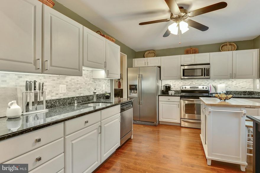 Move Right Into your Beautifully Updated 3 BR, 1.5BA, 1564 SF End Unit Townhome in Blue Ribbon School District Minutes from Annapolis.  Your Entire Family will ENJOY the Gorgeous Hardwood Floors, Renovated Kitchen w/Granite Counters, SS Appliances &  Marble Backsplash, Beautiful Stone Fireplace w/Custom Bookshelves, Perfect Powder Room w/Quartz Wall & Marble Floors, Bright Sunroom and Pretty Yard
