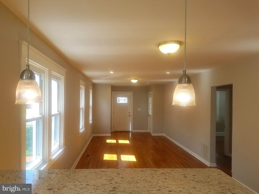 Renovated home in super convenient location. Updated new kitchen with breakfast bar & stainless steel appliances. The main level offers a open layout with living-dining-kitchen combo with 2 spacious bedrooms and warm hardwood floors. Upstairs is a master suite with walk-in closet and its own full bath.  Large lower with a full bedroom, living space and a 3rd full bath. Covered rear porch.