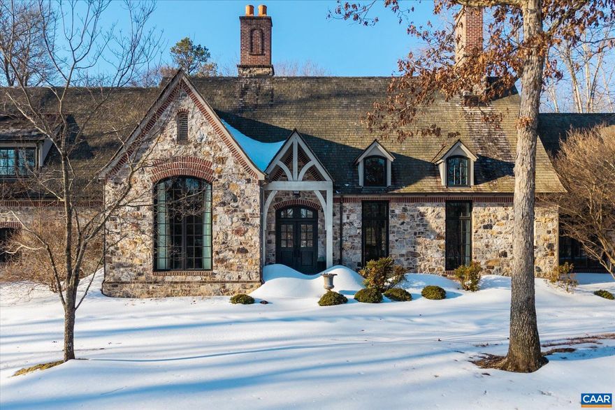 This remarkable 4 bedroom, 3.5 bathroom fieldstone residence was designed by Jack Arnold and constructed by revered local builder Ralph Dammann (now retired).  The private setting of the 3.5 acre lot will not change as all parcels around it have been built upon. Noteworthy features include soaring ceilings (10 ft minimum and main areas, 14ft), arched doorways, 2 oversized stone fireplaces (gas or woodburning) and an expansive rear, bluestone courtyard with access from the living room, primary and kitchen/family room. Timeless finishes include honed granite in the kitchen and large laundry room, heavy/high quality hardware throughout, cherry cabinetry and bookshelves in the home office and bar, and extensive built-ins in the family room.  Recent improvements incl' all new, high efficiency HVAC, tankless, instant hot water.  1 Gig+ fiber internet.  Public water & sewer.  The residence is within easy walking distance of all club and hotel amenities incl private and fine dining, golf, tennis, 2 pools, and incredible spa. Extensive trail system!  Under 12 minutes to Downtown yet a world away.,Granite Counter,White Cabinets,Wood Cabinets,Fireplace in Family Room,Fireplace in Living Room