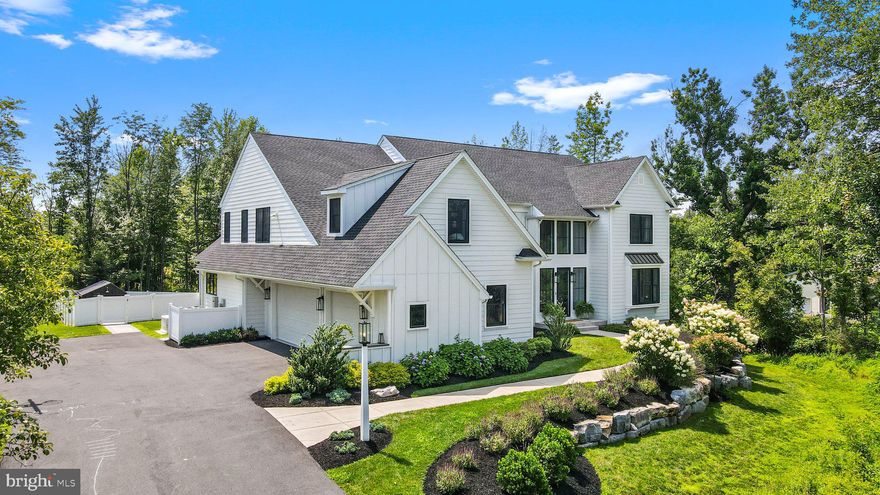 Better than NEW! This 4 year-young custom-built home offers all the perks of new construction with all the additional upgrades you could want! Situated on 1.5 acres in the coveted boutique community of Carriage Run, this home offers both a peaceful & private setting, backing to serene woods yet close to major routes, parks, & shopping. Upon arrival you are greeted by a lushly landscaped walkway leading you to the stately modern farmhouse. As you enter through the grand entry you’ll be taken aback by the light-filled open design. The epitome of modern living with 9’ ceilings, black & wood minimalist railings, white oak planked flooring, & large windows looking through to your back deck & fenced-in yard. The main floor study is perfectly suited for a work-from-home lifestyle. Adjacent is a large storage closet & powder room styled with attractive modern wallpaper & gold fixtures. The den is perfect for a playroom or whatever you could need, featuring custom built-in storage making it super easy to organize and clean up! The formal dining room flanks the entry & offers room for a 10’+ table, with custom lighting, & access to the kitchen through a functional butlers pantry with beverage cooler, storage cabinets & appliance garages. In the heart of the home you’ll find the kitchen, family room & morning room all open to one another. The gourmet eat-in kitchen features a large center island, built-in Thermador refrigerator/freezer, Bosch dishwasher, the highly attractive Superiore Deco Range, custom in-cabinet storage, built-in nugget ice maker, sonos speakers, gold fixtures, custom lighting & more. Not to mention a whole house AquaOX water filter/softener. The morning room looks out to your backyard & beyond to the private wooded area, making this space feel truly tranquil. Located perfectly for entertaining, the modern family room offers a gas fireplace & access to the back deck. Just off the kitchen you’ll find your dropzone with built-in shelving, shoe storage, large pantry space, & access to both the laundry room & garage. The 3-car garage is sure to meet any car-enthusiasts dream with three bays with epoxy floors, a hardwired electric car charger, & custom shelves. Back inside on the lower level, with its own private entry, you’ll find two bedrooms, a full bath, and an open concept living, dining, & kitchenette area, equipped with a Smeg refrigerator, dishwasher, sink, tiled backsplash & more, perfect for an au-pair/in-law suite. There is also ample room for storage in the utility room & a sliding barn door pantry. Heading to the impressive 2nd level, you’ll find the primary suite featuring peaceful wooded views, vaulted ceilings, a sitting room, private en-suite with soaking tub, glass surround stall shower, a private water closet, & a massive, custom walk-in closet, complete with several windows & center island storage. The 2nd bedroom on this level has its own full bath & extra spacious closet. There are two other bedrooms that share a jack-n-jill bath with dual vanities & attractive tile & finishes. There is also a covered juliet balcony off of the catwalk. The butterfly staircase leads you back to the family room & kitchen area & is styled with attractive shiplap & lighting. Outside, you will love the large composite deck that leads you to a stone patio & your fenced in backyard. The deck has storage underneath for all your seasonal items. Outfitted with a playset, attractive chicken coop with electric, an auto waterer, auto door, & a whole house generator, your homestead is now complete! This property is truly one of a kind, fully outfitted, customized & ready for its new owner. Only an out of state move makes owning this "forever home" possible and the opportunity will not last long!