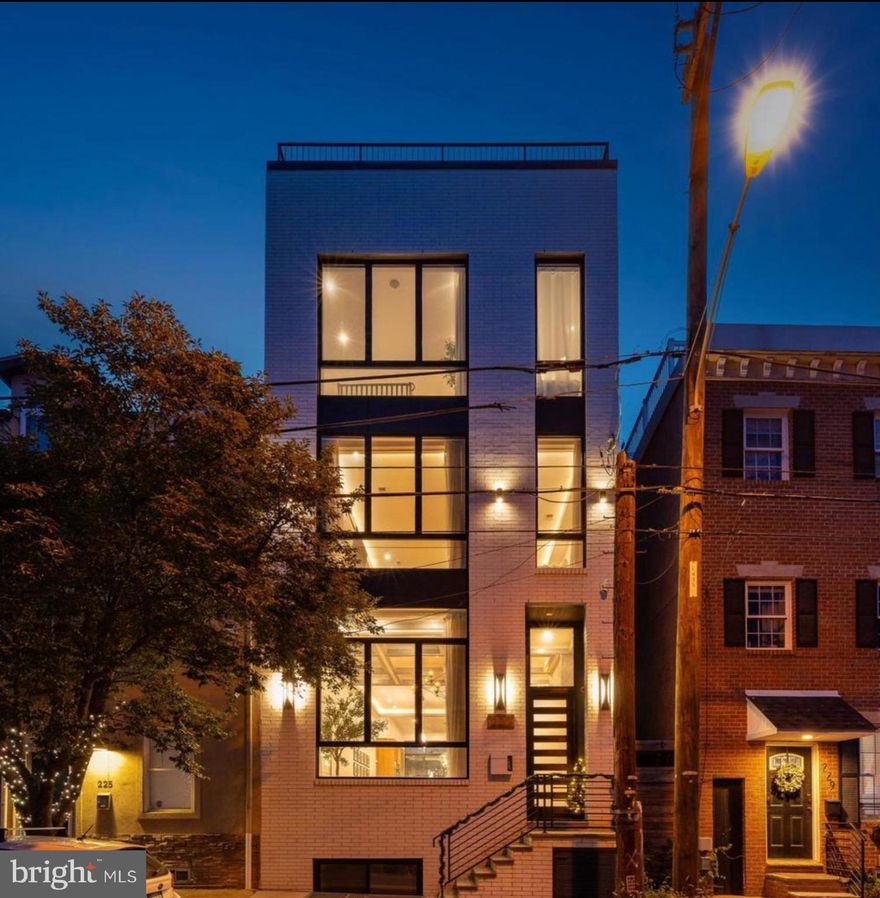 Architectural Elegance in the Heart of Fishtown – 227 E Allen Street

Discover elevated city living in this one-of-a-kind custom residence located in the dynamic Riverside/Fishtown district of Philadelphia. This four-bedroom, four-bathroom masterpiece blends contemporary design with premium craftsmanship, offering an unrivaled lifestyle across five thoughtfully designed levels—all seamlessly connected by a private elevator.

Step into the grand first floor where soaring 13-foot coffered ceilings and a dramatic gas fireplace wrapped in floor-to-ceiling tile set the tone for luxury. The open concept floor plan flows into a striking dining area with a lit tray ceiling, leading to a chef-caliber kitchen featuring high-end European cabinetry, integrated appliances, a built-in pantry with beverage center, and a dedicated coffee bar. Step outside to a private patio—ideal for al fresco dining and entertaining.

The second level hosts a spacious bedroom, full bath, custom dry bar with beverage center, and a stylish lounge area with an electric fireplace and custom shelving. The third floor features another spacious bedroom with a walk-in closet, hallway full bath, and a convenient wet bar. The luxurious primary suite is also located on this level, boasting a custom dressing room and a spa-inspired ensuite with a soaking tub inside a rainfall shower enclosure, LED-lit mirror, and dual vanities.

Take the elevator to the rooftop oasis—an entertainer's dream with panoramic skyline views, a pergola, gas and water hookups, and built-in audio for seamless indoor-outdoor living.

The fully finished basement expands your living space with a fourth bedroom, designer full bath, home theater/workout area, and yet another wet bar—perfect for game nights or hosting guests.

Additional features include built-in Sonos audio throughout, premium lighting upgrades, and a 10-year full tax abatement (approx. through 2031). Square footage and taxes to be verified by buyer.

Ideally situated near the vibrant scenes of Fishtown and Northern Liberties, with easy access to major routes like Delaware Avenue, this home offers unmatched urban convenience and quiet luxury.

Too many custom touches to list—this is a must-see.

Schedule your private tour today. Contact R.J. Timlin a