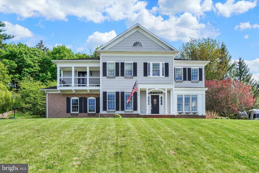 This home is located near a Park with tennis courts and pavilion and the Rail Trail for walking and biking, the 2 Story Foyer makes for an impressive entrance, hardwood floors, crown molding and picture framing add to the charm, the Kitchen has an island, a pantry, a Butler's Pantry, commercial size refrigerator/freezer, 6 burner & grill 9000 BTU dual zone stove and pot filler, the Primary Suite and bathroom offers 2 vanities, jacuzzi tub, separate shower, 2 Walk-in-Closets and door to balcony, there is a "Jack & Jill" bathroom between 2 additional bedrooms.  From the kitchen,  a door leads to a covered patio and wooded lot, the heating and air conditioning is 2 zoned, there are glass doors between Living Room and Family Room, the ceilings are 9 feet and 10 feet in the Basement, a Radon Mitigation System,  and there are pull down stairs in the Primary Bath Walk-in Closet