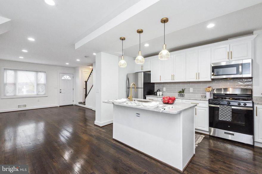 Welcome home! This fully renovated end of row townhome is simply waiting for you to move in. Key updates include refinished hardwoods and a fully remodeled kitchen with granite counters, new cabinets, and stainless steel appliances along with recessed lighting. The open living space on the main level is perfect for entertaining family and friends. The living and dining space is full of natural light thanks to all of the windows. The remodeled kitchen is a showstopper with beautiful cabinetry featuring gold accents, stainless steel appliances including the dishwasher in the island, and a breakfast bar with space to pull up stools for additional seating. The backsplash and pendant lights are the perfect finishing touches to pull together the kitchen space. The gleaming hardwoods carry throughout the main and upper level. Upstairs you will find three bedrooms that all have ceiling fans and a full bathroom has been newly updated. The lower level has plush carpet, recessed lighting, laundry, and a second updated full bathroom. The oversized back porch is ideal for outdoor dining and grilling! It is covered and has stairs leading down to the spacious fenced yard. Finally, there is a must-have gravel parking pad in the back! Additional updates include a new washer/dryer, new HVAC, and a new tankless water heater. This home is a gem and one you'll be proud to call your own!