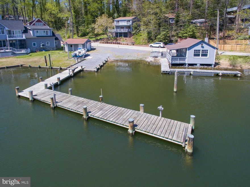 Beautiful waterfront - freshly updated! Bright and airy with amazing views! Home was rebuilt in 1986. Property has 2 piers, boat ramp, an outbuilding, detached garage, plenty of parking and includes multiple adjoining lots. New flooring throughout most of the home, interior & exterior painted in March '16, Lots 19, 20,9,10,11,12, & 13. Deepwater & ability to operate as a commercial marina.