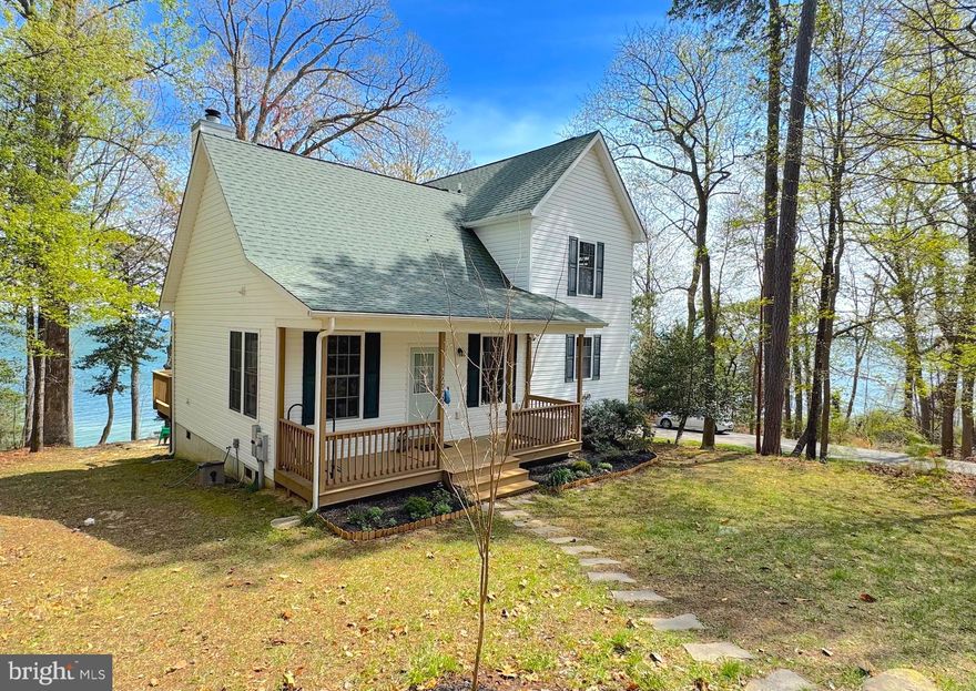 WOW, you are absolutely going to fall in Love with this adorable cottage that is just steps from a trail that will lead you to a secluded beach along the shoreline of the Chesapeake Bay. Located on a quiet street in the amenity rich community of Chesapeake Ranch Estates. This community offers so much: -> Airport -> Campgrounds -> Clubhouse ->  2 Amazing Beaches on the Chesapeake -> Community Gardens -> Horseshoe Pit -> Lake Lariat + Beach -> Walking Trails and more! This well designed cottage was built in 2014, and offers a light filled primary suite on the waterside of the main level along with an open floorpan where the kitchen, dining and family rooms flow seamlessly together. The 2nd level is well appointed with two nicely sized guest bedrooms that are divided by a Jack & Jill full bath. The views of the Chesapeake can be enjoyed from most rooms within the house, as well as the rear deck, or the bayside fire pit area a perfect spot for watching the boats and ships pass while enjoying quality time with friends and family.  Let the sounds of the Chesapeake sooth your heart, mind and soul in a home that offers just what you need without all the complications.