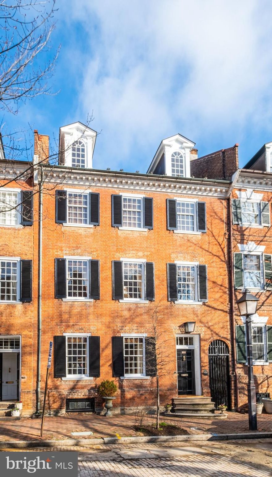 Outstanding 5 Bedroom home on Gentry Row built by Captain John Harper in 1784. Featuring exquisite chair and crown moldings, 8 fireplaces and grand ballroom on the second level. Flooded with sunlight from oversized original windows, this house offers beautifully preserved original heart pine floors, double parlor living and dining rooms with fireplaces, a full length glass door opening to the brick walled garden and beautiful keystone arch between the double parlors as well as in the beautifully proportioned entry hall. 
On the second floor off the ballroom there is a wet bar and a library with a fireplace and a hallway leading to a guest bedroom with private bath as well as the elevator running to the kitchen below or the third floor above. The third floor features a grand primary bedroom with en suite bath, fireplace and three closets, as well as an additional bedroom, hall bath and a generous room utilized as an exercise room and laundry room.  The entire top floor boasts an open bedroom or family room space with original beamed ceiling and full bath plus access to a small attic space above. 
Located in the very heart of Old Town, this is a true gem enjoyed and appreciated for many years by the fortunate owners and residents.