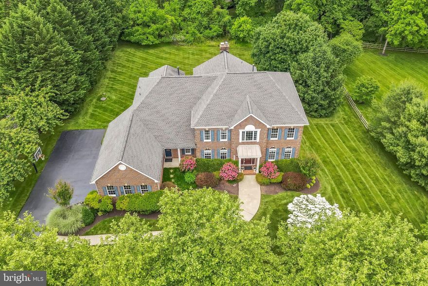 Presenting this stately Toll Brothers Coventry model boasting over 7,000 square feet of luxurious living. Located off Route 32 and accessed by beautiful country roads, this small community of 49 estate homes, gives you the perfect balance of a neighborhood and a country setting. Nestled on over an acre on a non-thru street, this home’s mature landscaping provides privacy and tranquility. Inside this residence features 5 bedrooms and 5.5 bathrooms. With plenty of space for entertaining, the main level floor plan is perfect for gatherings, but also offers all the amenities for convenient daily living, including a mudroom, walk-in pantry, private office, and back, secondary staircase leading upstairs. Surrounding the kitchen is a large dining area and solarium, adorned in windows, allowing ample natural light and providing access to the maintenance free screened-in porch and deck.  Upstairs, retreat to the grand primary suite with tray ceiling and sitting room, along with three additional bedrooms, each with their own private, ensuite bathroom. There are custom closet organizers in the primary walk in closet and two other bedroom closets. The walkout lower level features even more living space. With its 9 foot ceilings and plenty of windows to bring in the natural lighting, it is the perfect spot to retreat and/or entertain. There is a bar area complete with full size refrigerator, wine cooler, sink, and dishwasher. There is an additional bedroom and full bathroom. The living space continues with a “bonus room/den,” as well as a designated “craft room.” Other features and details of this home include 9 foot ceilings on the main level, hardwood flooring, gas fireplace in the main level great room and a wood burning fireplace in the lower level great room. There are 3 HVAC units, gas heat, gas hot water heater, water softener system, surround system in lower level, roof is 5+/- years old. The stair lifts can be removed by seller should buyer not need.  A one year home warranty is also being included. Home also has 9' ceilings on all three levels.