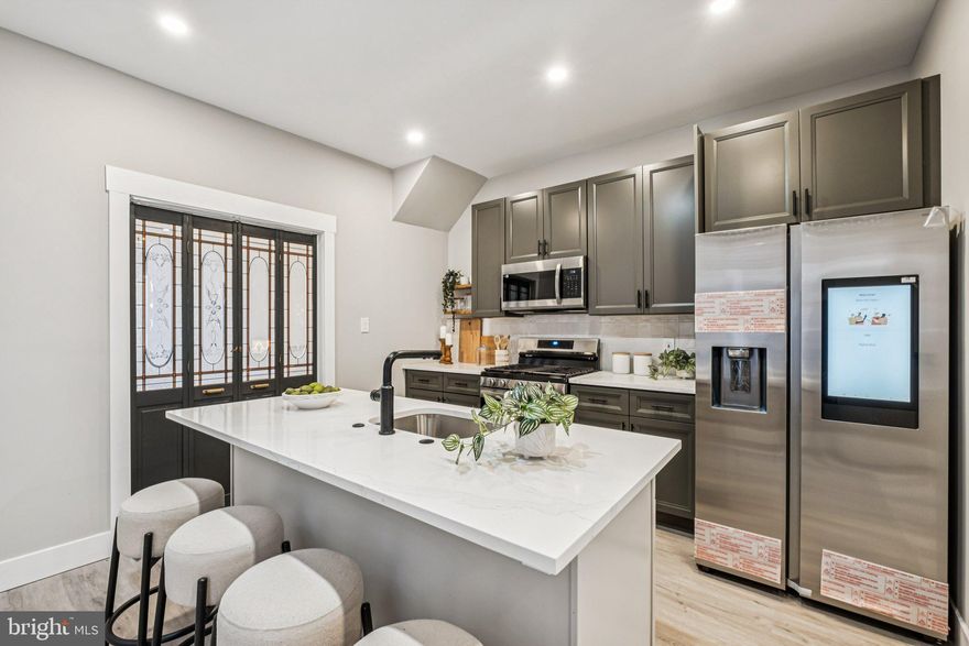 Fully renovated three story home in Germantown with more than 2,000 square feet, a finished basement, and a standout primary suite.

This four bedroom two and a half bath home has been rebuilt with a thoughtful mix of modern design and preserved character. The kitchen is the centerpiece of the main floor, featuring quartz countertops, shaker cabinets, an island with a dishwasher, floating shelves, and all new stainless appliances including a smart hub Samsung fridge and a five burner gas stove.

The second floor includes a true primary suite with a large walk in closet and a beautifully finished bathroom with a stand alone soaking tub, a double vanity, and high quality tile work. The hall bath also features a striking glass tile surround that sets it apart.

The living room is bright and inviting, and includes an original folding-style passage door with preserved glass paneling. It is a unique architectural feature that gives the home character while keeping the layout functional. Additional details include five-panel interior doors with new hardware, and luxury vinyl flooring throughout.

The home has a brand new high-efficiency HVAC system, updated plumbing and electrical, and a finished basement that is perfect for a gym, office, playroom, or media space. The fenced grassy backyard offers plenty of outdoor space.

Located across from a school with easy street parking, this quiet residential block is well kept and welcoming, with long time neighbors and new families moving in. Close to Pulaski Avenue, transit, parks, and local shops.

Schedule your showing today.