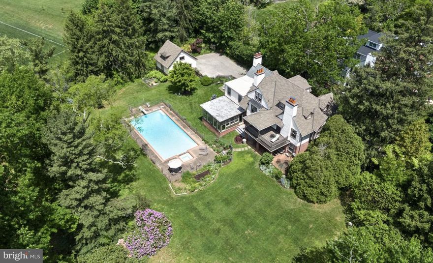 Welcome to 824 Buck Lane.  The generous, historic house provides warmth, elegance, and modern comforts insulated by the beauty of nature. The home offers an inviting, open layout that effortlessly accommodates family and friends, reflecting its solid construction and thoughtful design. The house was built with airflow and light in mind; sunlight streams throughout many of its rooms. 
In keeping with its old world charm, the house has been thoughtfully updated while preserving the original millwork, fireplaces, cozy window seats and easy flow that is its hallmark. In addition to custom bookshelves and tilework, the family room is a particularly beautiful and inviting conception. It faces sunset with three walls of windows, including two sides of large casement windows that, when open, make the room feel much like a screened in porch. Delight in views of the idyllic yard, nurtured by decades of organic gardening.
This elegant residence includes 6 bedrooms, 4.5 baths, and a detached garage, perfectly complemented by a covered porch and a second-floor balcony offering serene views.                                                                                             
As you enter, the reception hall greets you with bench window seats, custom shelving, and hardwood flooring, leading seamlessly to the expansive living room adorned with a fireplace and cushioned bench seating. The adjacent dining room, with its triple window and fireplace, connects to the family room through the pantry, creating a seamless flow for entertaining. The family room opens to the rear grounds and covered patio, ideal for indoor-outdoor living. The heart of of 824 is the kitchen and family room which spill easily into the yard for outdoor dining or leisurely afternoons by the salt water pool.      
Experience the joy of gatherings in the welcoming front hall, pantry/bar, and kitchen, culminating by the living room fireplace. 
The second floor hosts 4 bedrooms and 3 baths, including a primary bedroom with a freestanding tub, while the third floor offers 2 additional bedrooms and a shared hall bath, all adorned with hardwood floors and ample natural light.
Outside, the driveway is lined with Belgian block detailing, leading to a one-car garage with a room above, complete with electricity.                                                                                                                                                                                                                                                                                                                                                                                                                                                      Noteworthy upgrades include Marvin double pane windows, re-roofed (twice), rebuilt sleeping porch, renovated primary bath, zoned the heat system and replaced most of the old windows with Marvin windows, added many book cases, fenced-in yard, repaved driveway and added cobblestone to front door entrance, replaced oil with gas furnace, added insulation for year-round comfort, and a meticulously landscaped yard enveloped by parkland for unparalleled privacy. Recent additions include a large family room designed by Alan Powell and a second main bedroom and bathroom envisioned by Peter Zimmerman, epitomizing luxury and craftsmanship.
This distinguished residence, steeped in rich history, once served as a Quaker boarding house and refuge for World War II immigrants. Their experience is chronicled in the diaries of Christopher Isherwood.
824 is centrally-located to excellent academic institutions , the arboretum and nature trails of Haverford College and convenient amenities such as the train station, hospital and vibrant town centers of Haverford Square and Bryn Mawr.
Experience the perfect blend of historic elegance and modern luxury at 824 Buck Lane. This home is a rare find, offering a haven for generations to come.