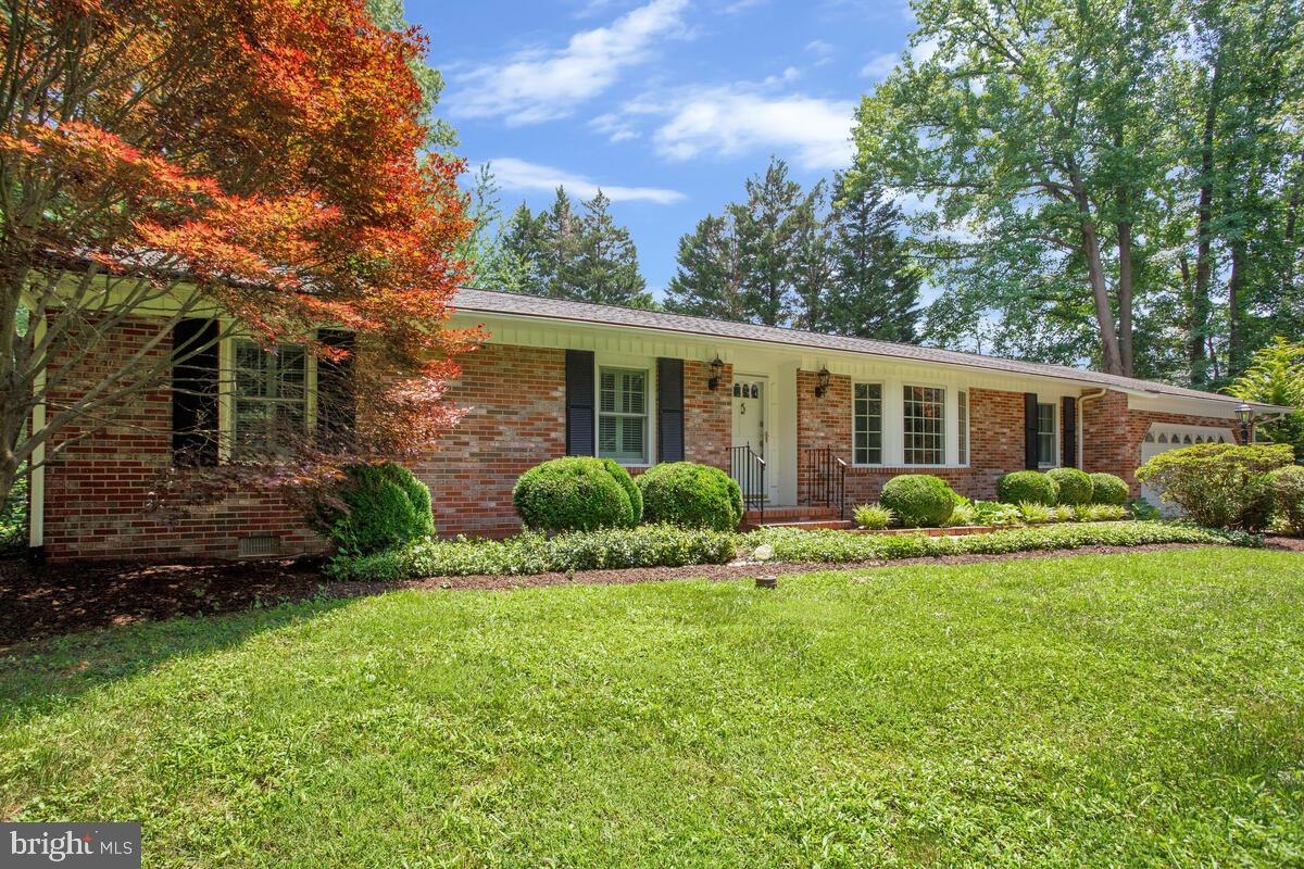Welcome to this beautifully maintained brick rancher nestled on a private, elevated lot in the desirable Hardesty Estates community. Surrounded by mature landscaping, this home offers classic charm, and peaceful living in a picturesque setting. Inside, you'll find hardwood floors throughout, a spacious living room with a bow window that fills the space with natural light, and a separate dining room with glass doors—perfect for entertaining. The country-style kitchen features an eat-in area and opens to a step-down family room with a cozy wood-burning brick fireplace. The main-level laundry room adds convenience with an entry from the garage and a half bath. The primary suite includes its own bath with walk in shower. There are 2 additional generously sized bedrooms. Enjoy outdoor living on the large patio or relax in the screened porch overlooking the beautifully landscaped yard. This is a rare opportunity to own a thoughtfully designed home with timeless character and serene surroundings in one of the area's most welcoming neighborhoods.