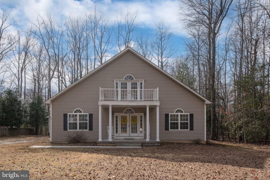 Why wait for new construction when you can have this wonderful custom home now!  Priced to sell!  Nestled on a quiet street backing to beautiful mature woods!  Rare large lot measuring .76 acre!  This custom two story home boasts 3 spacious bedrooms and 3 full bathrooms!  The welcoming covered front porch leads you into a spacious foyer with wood floors and expansive coat closet!  Enter left into your beautiful living room with a freestanding gas fireplace and multiple Palladian windows!  Gleaming wood floors throughout main living areas and a flowing open floor plan!  Pass through to your gorgeous kitchen with upgraded cabinets, wood floors and pantry!  One level living at its best!  Primary bedroom with private full bath and walk in closet on main level!  Laundry room with sink, storage, shelving on main level!  Second main level bedroom has two closets!  Second main level bathroom has a soaking tub!  9 foot ceilings on both levels!  Palladian windows throughout home offering tons of natural light and all around gorgeous views!  Upstairs offers a spacious loft area with gorgeous views of the back yard and wildlife!  Two large attic areas offering tons of storage!  Lovely upstairs bedroom with private bath, walk in closest and French doors to balcony offers such a wonderful relaxing retreat!  Loft has so much potential!  Use as a family room, office, studio or separate sitting room to compliment your upstairs private retreat!  High speed internet! Conditioned crawl space!  Detached garage with garage door opener!  Deep front yard just waiting for your weekend cook outs and gatherings!  Relax on your rear deck and enjoy all what nature has to offer!  Stratford Harbour is a wonderful walking community with a beautiful private lake, sandy Shark's Tooth Beach, community playground, courts and high speed internet!  This unique community offers a la cart amenities that you will want to use, such as a marina, outdoor pool, boat/RV storage, clubhouse and more!  Perfectly placed on a non-thru street!  You will not be disappointed.  Don't miss out on this opportunity!