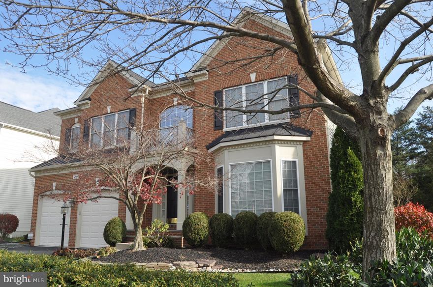 Sight Unseen Offer Accepted. Beautiful brick front colonial on gorgeous lot backing to trees.  Main level features a bright open floor plan with hardwoods, custom moldings and trim, 2 story foyer, formal Living and dining rooms, private home office, gourmet kitchen with granite counter tops, huge custom kitchen island, double wall ovens, stunning family room with surround sound and floor to ceiling stone fireplace.  Foyer window and family room upper windows have 3M UV 99+ protection (excellent temp control and no fading of floors or rugs from sun light).  Upper level includes 4 bedrooms and 3 full baths an impressive master suite with walk in closets, luxury bath with soaking tub, separate sinks, and shower with seat. Lower level has a spacious recreation room with wet bar rough in, a 5th Bedroom, full bath, additional finished room wired and ready to be a media room.  2 car front load fully insulated garage with double sided insulated garage doors with custom Gladiator Systems slotted walls, custom flooring, metal cabinets, work bench. New roof in 2016 with Gutter Helmet protection.  New HVAC 2015.  Custom landscaping, recessed lighting in all rooms, floor electrical outlets in living and family rooms.  Meticulously maintained by original owners.  Enjoy South Village amenities, private community pool, tennis, tot lots, playgrounds, parks, and walking trail.