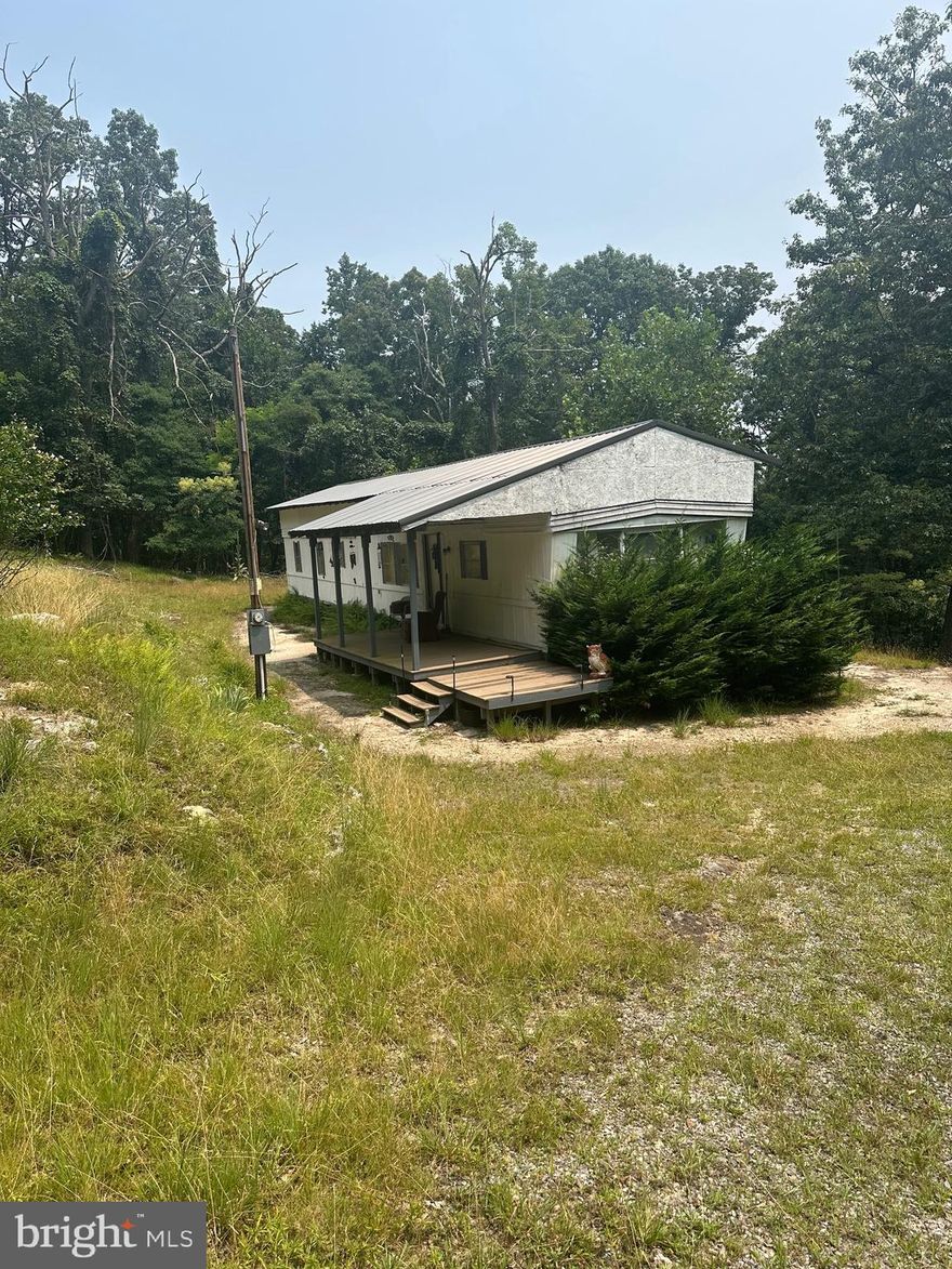 Are you looking for seclusion and privacy?  Look no further! This property located in the mountains of Great Cacapon is just what you’re looking for! This property consist of two lots, one lot has a single wide trailer on it and the other is improved with a well, septic , and electric. The single wide trailer is a 2 bedroom 2 bath, new metal roof built over the structure. All furniture and everything in the trailer will convey minus the dresser In the master bedroom and the china dishes. This was used a weekend retreat by the seller. This property would make an awesome hunting retreat, it’s only miles from sidling hill wildlife management area. The well is on the property but has not been hooked up to the trailer. Septic and electric is hooked up to trailer. The older trailer on the property was used for storage. Adjoining lot is also included in the sale.