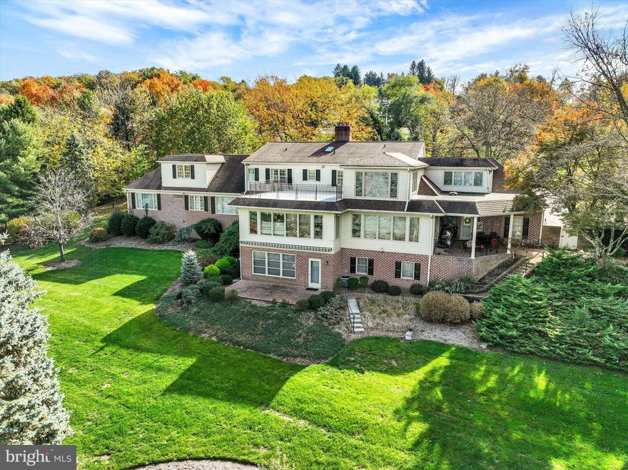 Experience a rare blend of timeless elegance, architectural presence, and exceptional scale in this magnificent all-brick custom estate, perfectly positioned in the prestigious golf course community of Wyndham Hills with sweeping panoramic views of the York City skyline. A grand marble-tiled foyer creates an unforgettable first impression, many custom details  and craftsmanship, from custom accent moldings and four statement fireplaces to an elegant butler’s pantry and an abundance of beautifully appointed gathering spaces designed for both grand entertaining and intimate everyday living.
The first-floor primary suite is a true private sanctuary, offering an extraordinary level of comfort with three full baths, multiple walk-in closets, a dedicated office, and a serene sitting or fitness area. An elevator provides seamless access to all levels of the home.
The second floor features five additional spacious bedrooms, including a remarkable private suite with its own office, balcony, and a dramatic wall of windows that captures breathtaking views and natural light.
Designed for year-round entertaining, the finished lower level offers an additional bedroom and bath, a stylish wet bar, craft room, fitness area, fireplace, and a spectacular four-season room complete with an indoor grill — creating the ultimate space for hosting in every season.
Additional highlights include multi-zone heating and cooling, an updated architectural shingle roof, and an unbeatable location just minutes from the renowned York Country Club for premier golf and social experiences. Enjoy quick access to the York Rail Trail for walking, running, or biking, vibrant downtown York dining and entertainment, WellSpan York Hospital, and I-83 for convenient commuting north or south into Maryland.
This is more than a home — it is a statement of lifestyle. A truly extraordinary property that must be experienced in person to fully appreciate its scale, design, and unmatched entertaining potential.
