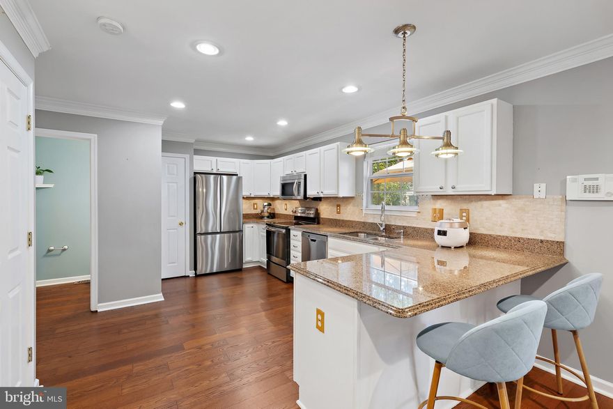 PRICE IMPROVEMENT! This updated 4-bedroom, 3.5-bath colonial is ideal for buyers who value interior space, layout, and move-in-ready condition over excess land, all within the highly sought-after Severna Park school district. Inside, the home features hardwood floors, crown molding, and an updated kitchen with granite countertops and stainless steel appliances, plus a brand-new roof with a transferable warranty for peace of mind. The upper level offers three spacious bedrooms, including a primary suite with a walk-in closet and a double vanity. The fully finished basement provides exceptional flexibility, with tile flooring, a private bedroom, full bath, and kitchenette—ideal for guests, multigenerational living, or work-from-home needs. Outside, the property includes two decks, a fenced yard, and off-street driveway parking, offering privacy and functionality while keeping outdoor maintenance simple. Conveniently located minutes from Kinder Farm Park, walking trails, shopping, dining, and major commuter routes.