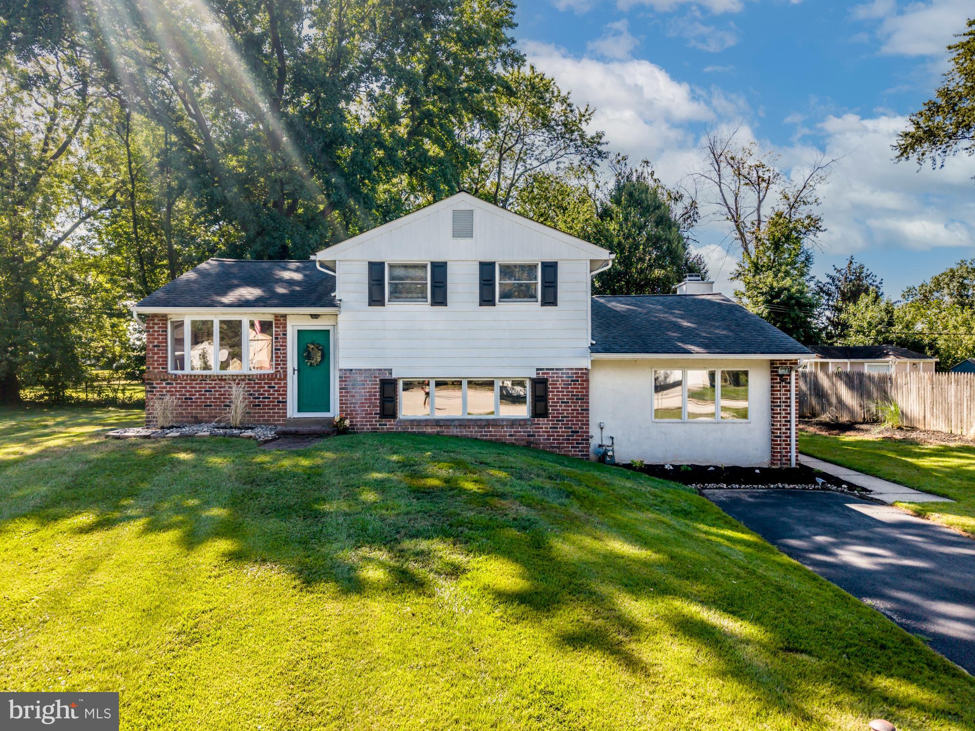 Welcome to this spacious 4-bedroom, 2-bath single-family home tucked away on a very large and quiet cul-de-sac—offering a fantastic opportunity for buyers who want to create a special space of their own and build equity. With over 1,800 square feet of living area on a park-like, 1/4-acre lot, this home has a serene setting and a flexible layout. The main floor features an open kitchen and dining area that flow into a large family room addition, complete with a vaulted ceiling, skylights, and a cozy gas fireplace. Sliders from the family room open to a patio and offer views of this home’s pretty backyard. A fourth bedroom on the main level provides options for a guest room, home office, or playroom. There is also a full bath and roomy laundry area on this level. Step up from the dining room to a bright living room with hardwood floors, a large bow window, and sliding doors that lead to a private deck—perfect for relaxing or entertaining. Upstairs, you’ll find three more bedrooms with hardwood floors, as well as a full bath, including a deep whirlpool tub for winding down after a long day. While nestled in a peaceful neighborhood, this home is conveniently located near Rt. 202, Trooper Road, shopping, dining, and more. Don't miss your chance to transform this hidden gem into the home of your dreams—schedule your showing today!