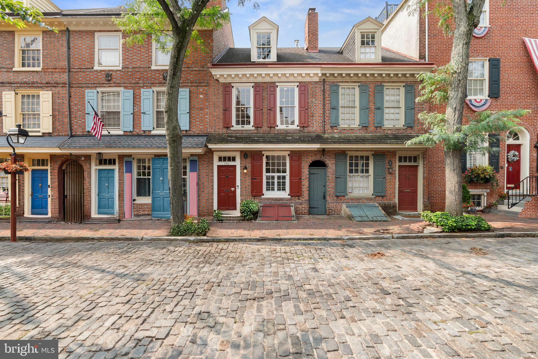 Travel back in time without sacrificing modern luxury at 246 Delancey Street, a pristine, thoughtfully designed 4 bedroom 2.5 bath home on one of Philadelphia's most picturesque and coveted blocks. Built circa 1767 by Joseph Wetherill, son of Christpher and Mary (Stockton) Wetherill and said to be the nephew of Richard Stockton, signer of the Declaration of Independence, this residence is proudly listed on the Philadelphia Register of Historic Places. A remarkable property for history lovers! Today, its random-width hardwood floors, preserved architectural details and lush garden are paired with tasteful modern updates offering a rare blend of colonial charm and contemporary comfort.
The main level is filled with natural light and features a spacious open floor plan with refinished hardwood floors, recessed lighting, elegant wainscoting, and a fireplace that serves as the focal point of the living space. The dedicated dining area connects to a fully equipped kitchen offering abundant cabinetry, a sleek range hood, under-cabinet lighting, a tile backsplash, and a breakfast bar with pendant lighting—ideal for both everyday use and entertaining. Beyond the kitchen, a private garden provides a tranquil retreat for urban planting or morning coffee.
The second level boasts a large sunlit primary bedroom with a ceiling fan, good closet space and recessed lighting, along with an ensuite bath featuring a dual vanity and a spa-like shower. A second spacious bedroom, a full bath with a tub/shower combo, and a conveniently located laundry closet complete this floor.
The third level offers two additional bedrooms—one currently used as a home office with a charming exposed brick fireplace. This level also accesses the most amazing rooftop deck with a pergola—ideal for dining al fresco or relaxing under the city sky.
Enjoy easy access to parks, including Three Bears Park -a beloved neighborhood hideaway, waterfront trails, Headhouse Square, farmers markets, acclaimed restaurants, and cultural landmarks—all just moments from your front door. As an added bonus, the seller is offering one year of parking around the corner at 215 Lombard Street for even more convenience in this prime location
Nestled on a storybook street in the heart of Society Hill, this historic gem is so captivating it draws admirers from near and far. Its charm and elegance make it picture-perfect in every season. It's a piece of Philadelphia’s history with thoughtfully designed spaces, both inside and out, for modern city living.